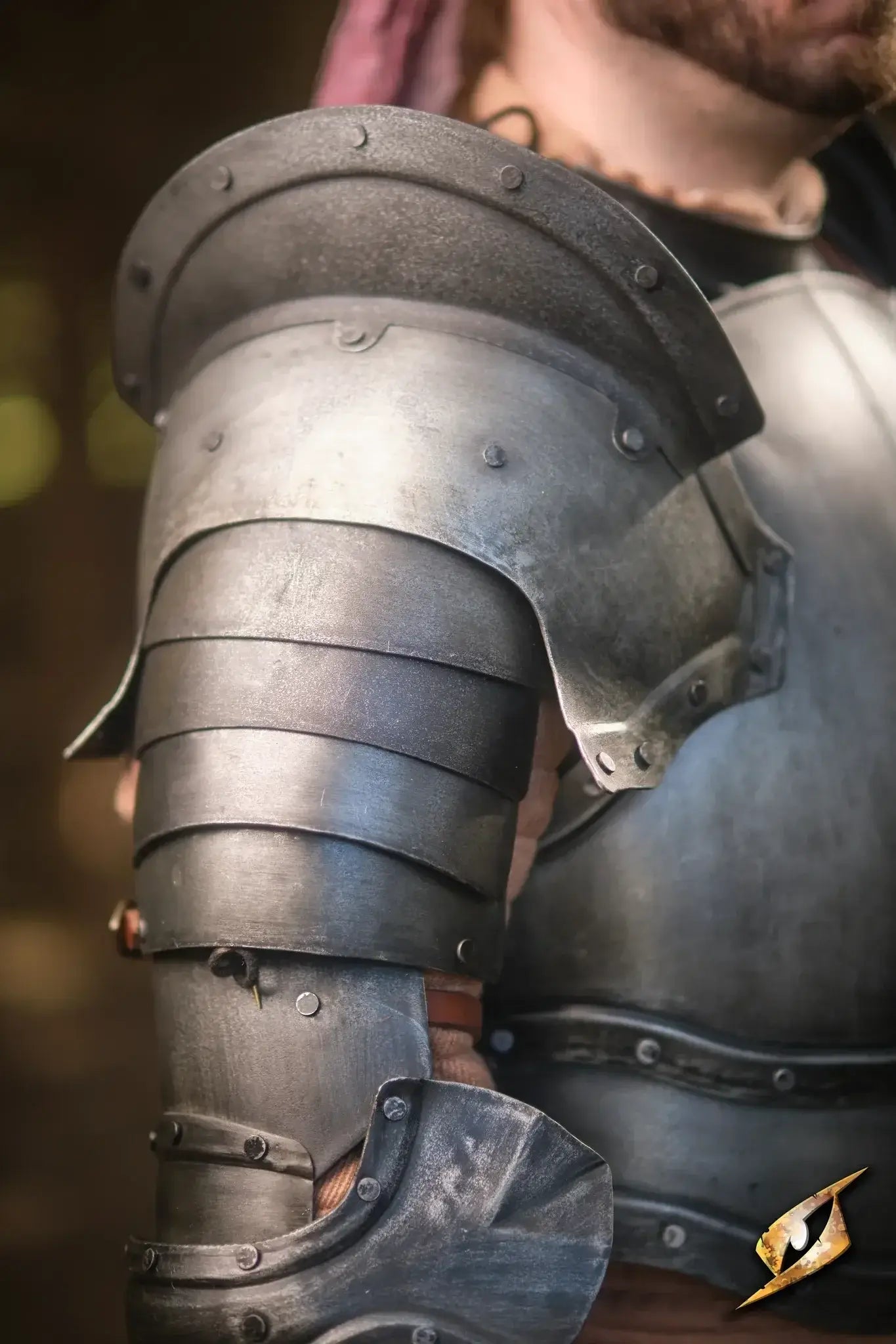 Close-up of detailed pauldrons showing shiny metal armor design, enhancing the overall LARP costume.