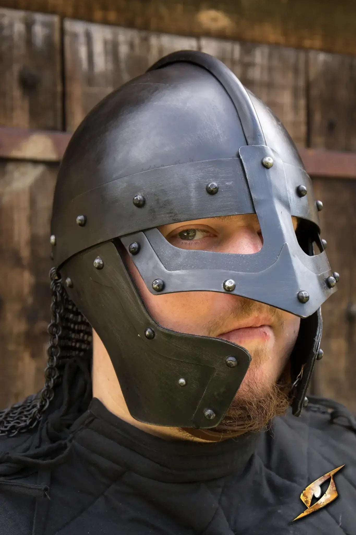 Viking Helmet worn by a man with a fierce look, showcasing detailed metal craftsmanship and historical design.