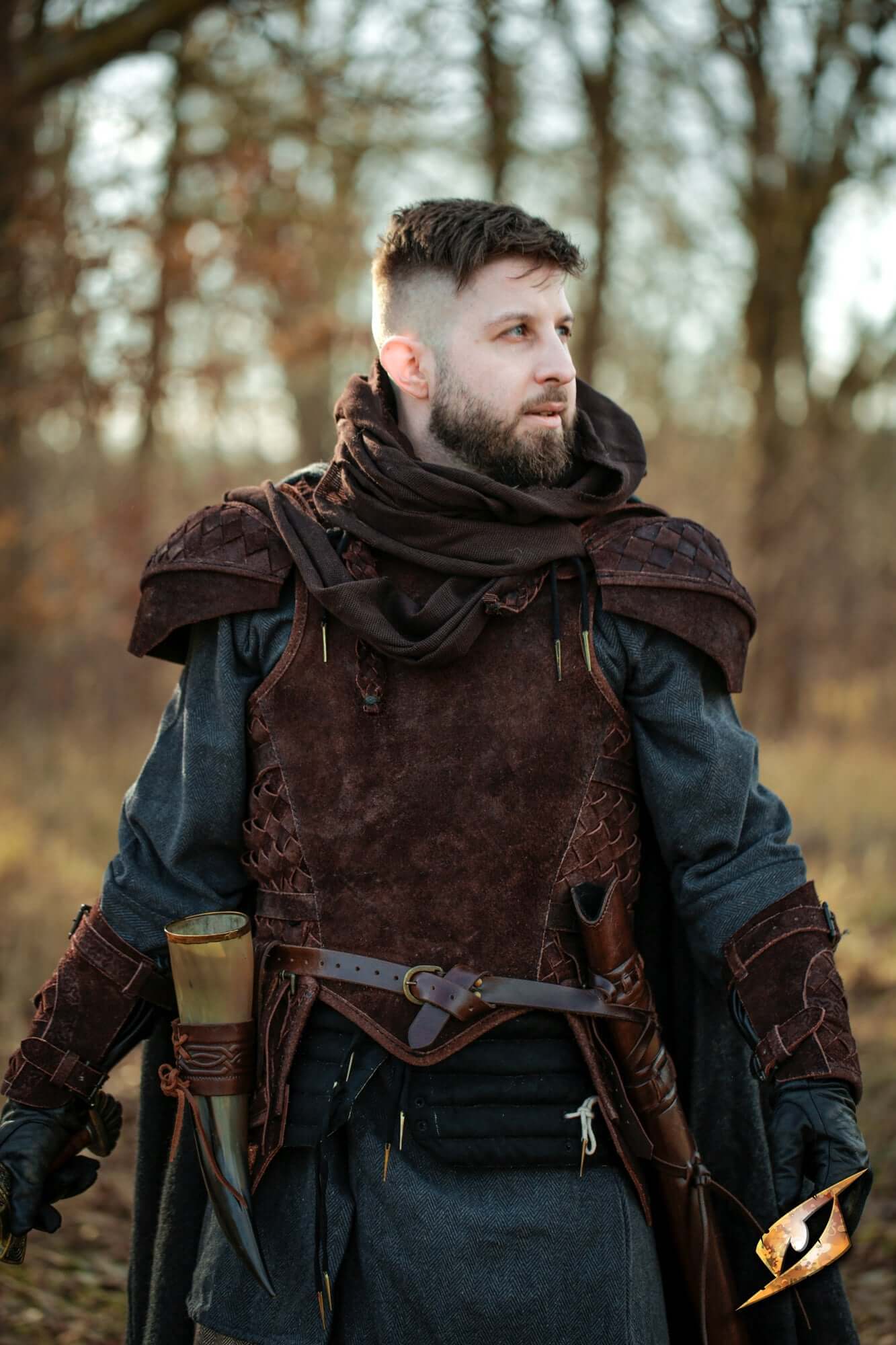 Leather Armor Sets featuring a warrior in detailed leather armor and cloak, perfect for cosplay and reenactments.