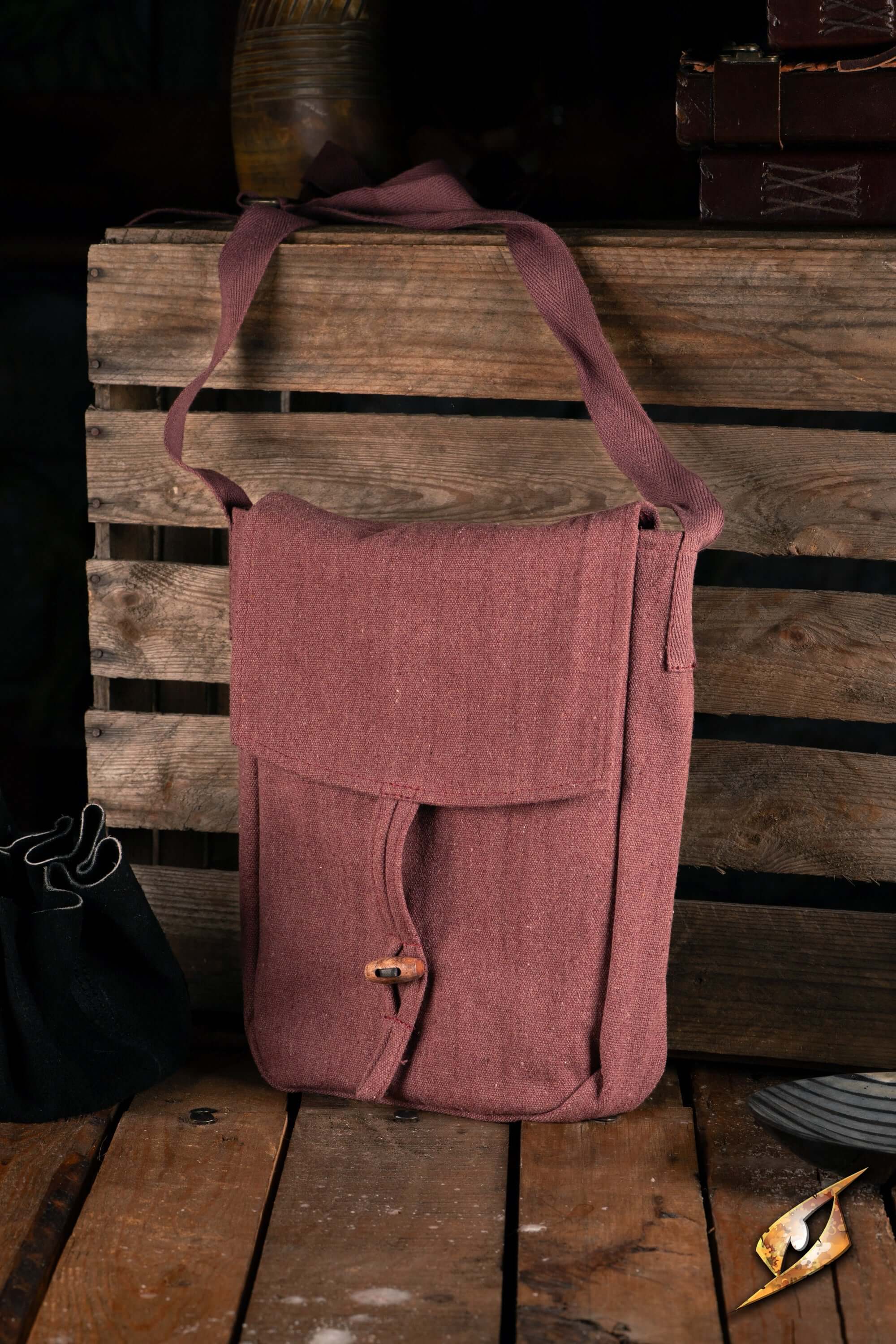 A brown canvas bag on a wooden table, in an indoor setting.