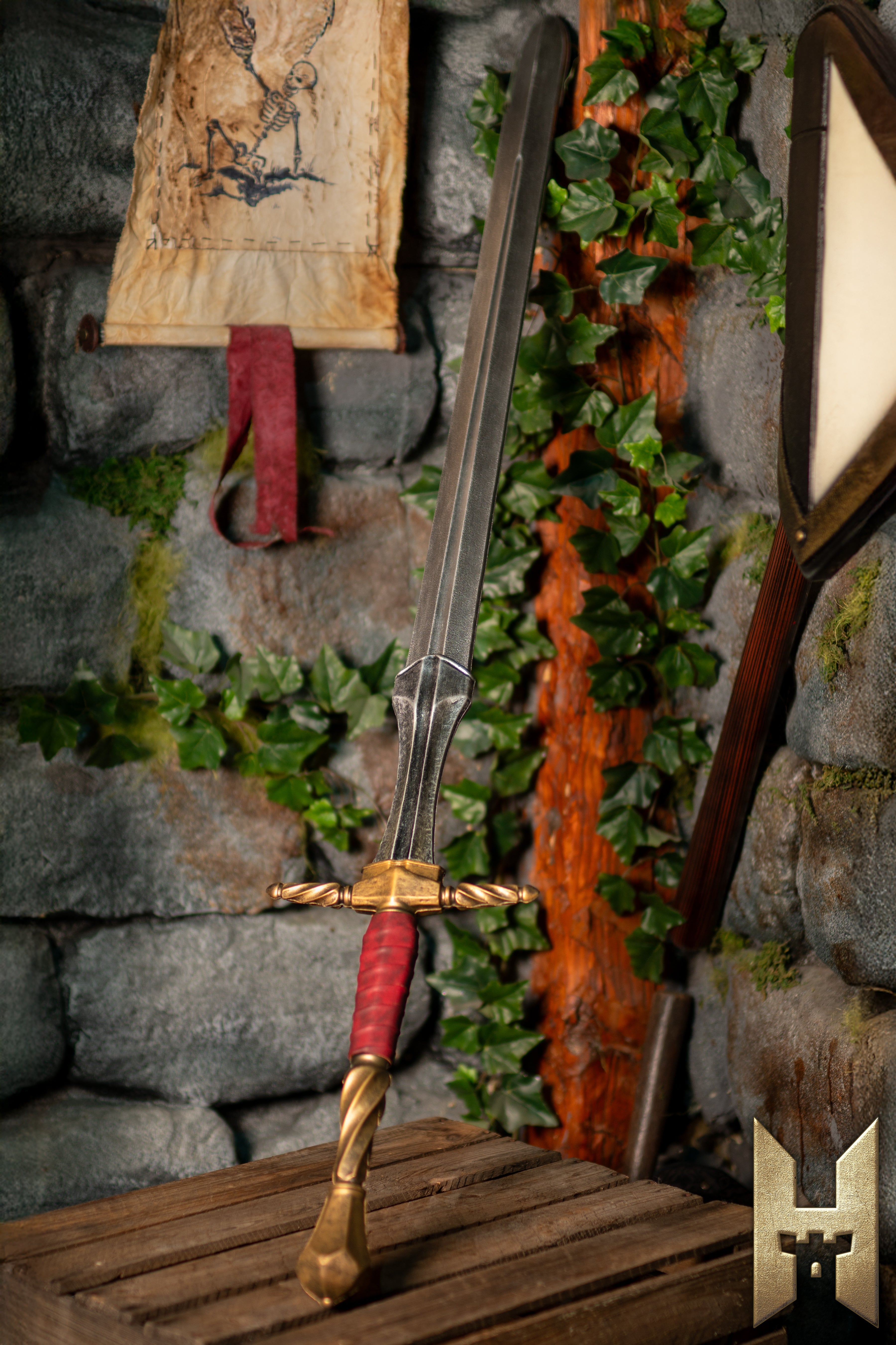 A beautifully crafted Medieval Sword displayed on a wooden crate, set against a stone wall and foliage.