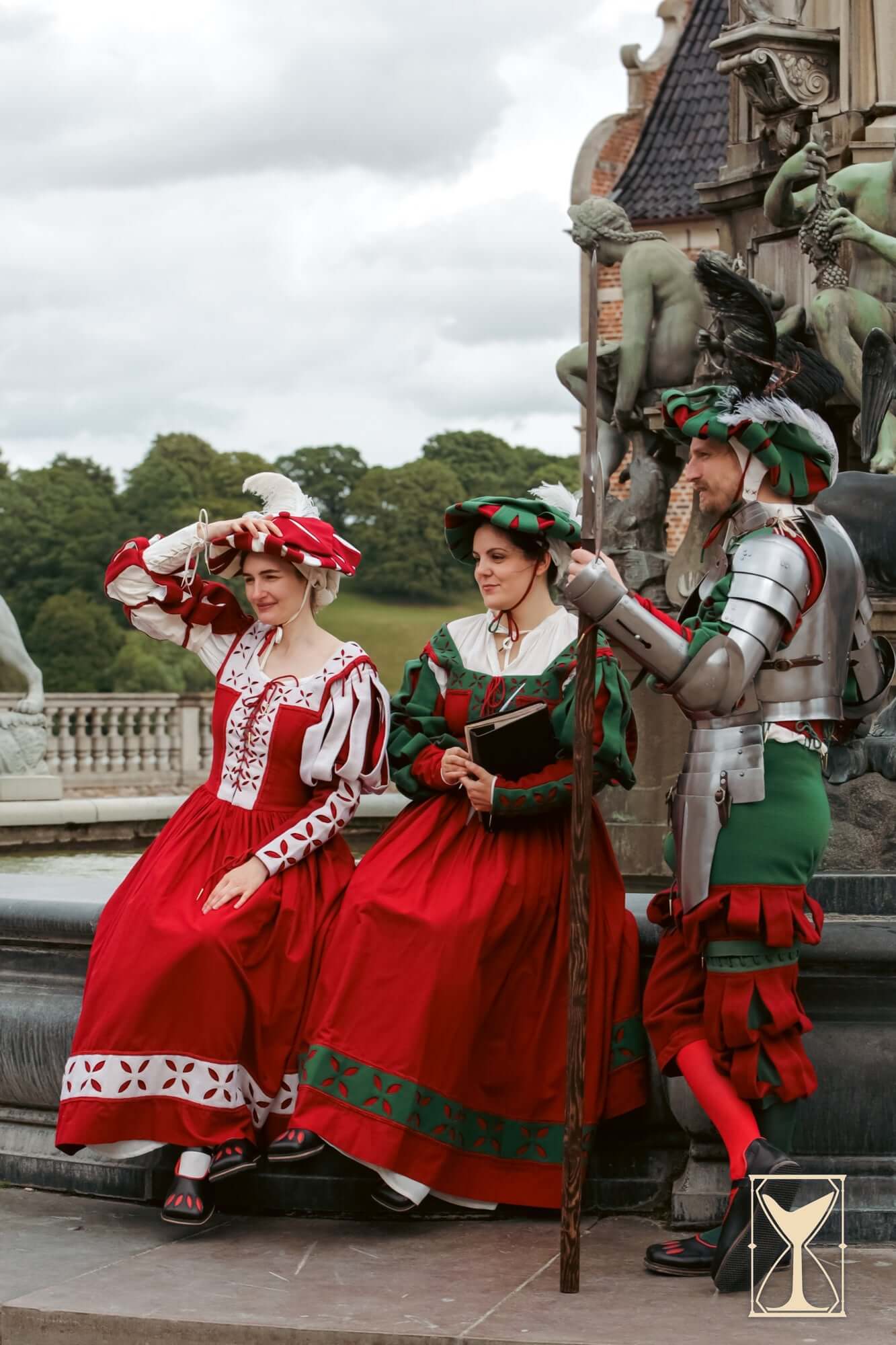 Landsknecht clothing worn by three historical re-enactors showcasing vibrant colors and unique styles.