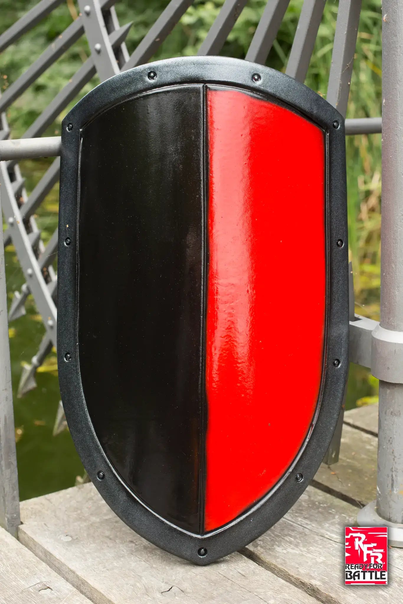 A black and red shield displayed outdoors, representing Battle Bundles collection.