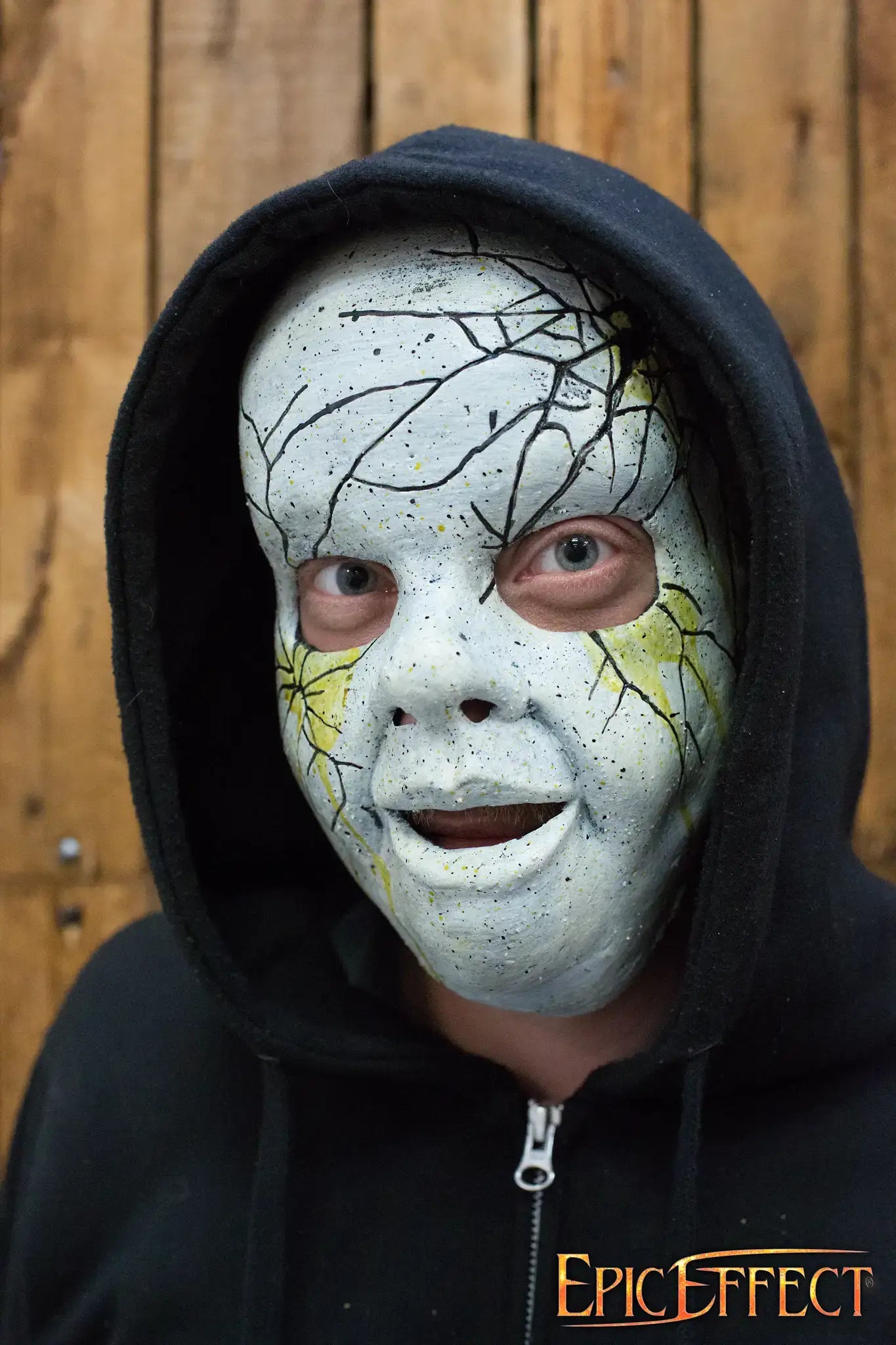 Person wearing a unique face mask with a cracked design, representing creativity in face masks.