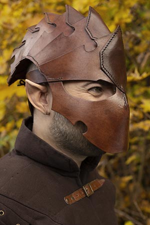 Man wearing a unique leather helmet, showcasing the craftsmanship of Helmets Leather collection.