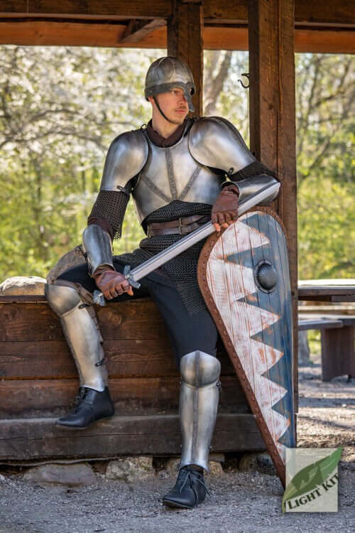 A knight in Light Kit armour sitting with a shield and sword, showcasing lightweight protection and polished appearance.