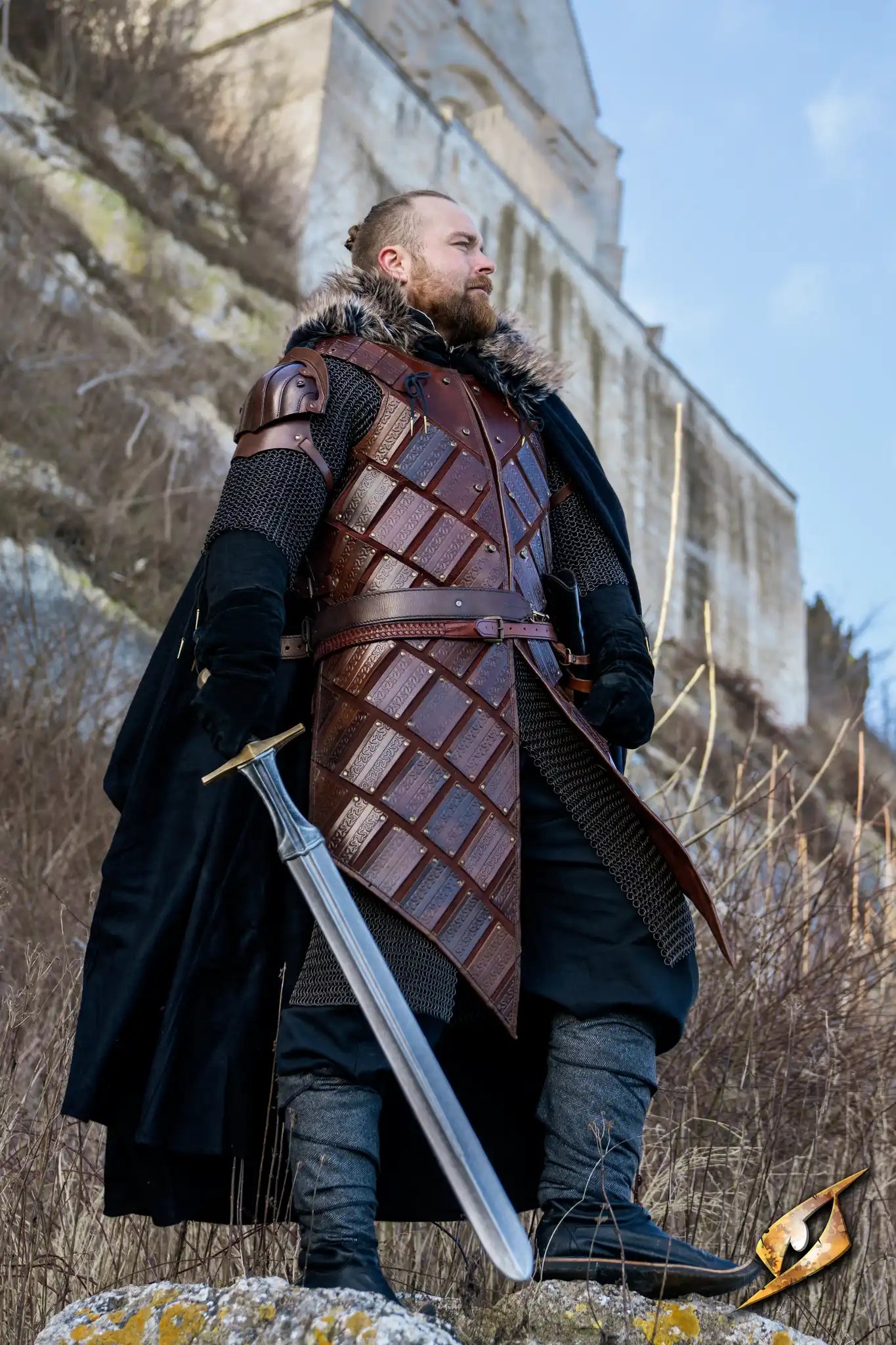 Man wearing Woodsman Armour, a dark brown leather brigandine with embossed details, holding a sword outdoors.