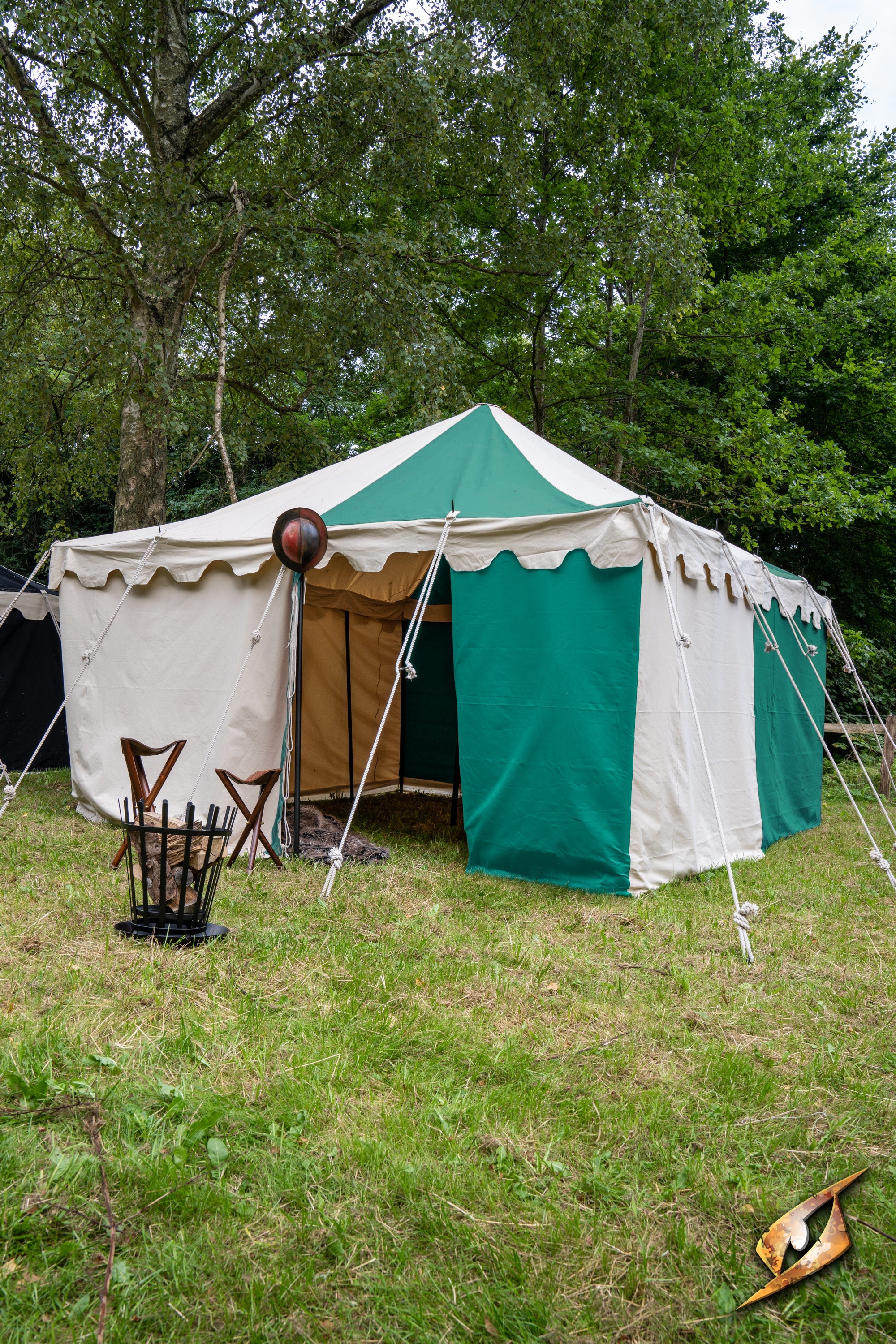 Marquee Tent - 4x4m set up in a grassy area, featuring green and white fabric, providing shade for outdoor events.