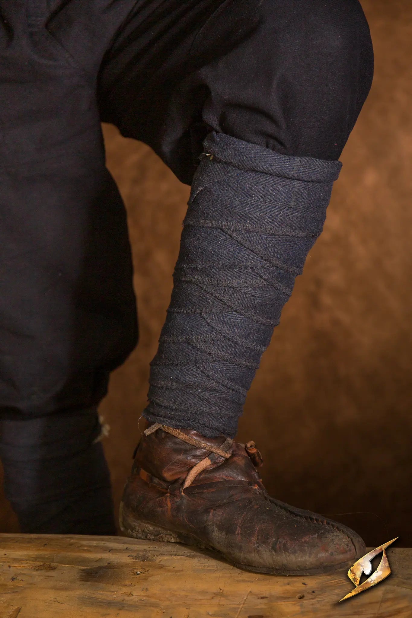 Woodland Leg Wraps shown wrapped around the leg, complementing rustic footwear for an outdoor adventure.