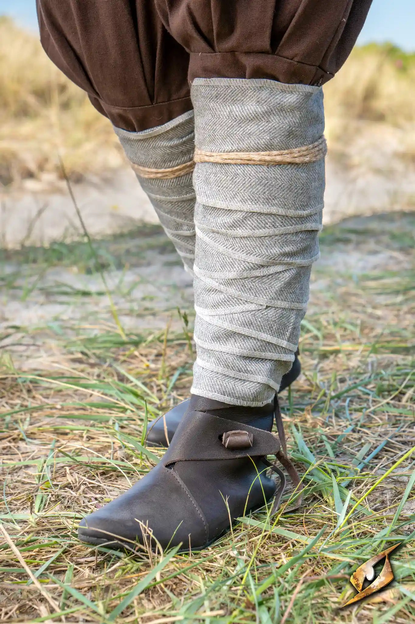 Herringbone Leg Wraps worn by a warrior, providing protection and stylish detail during LARP battles.