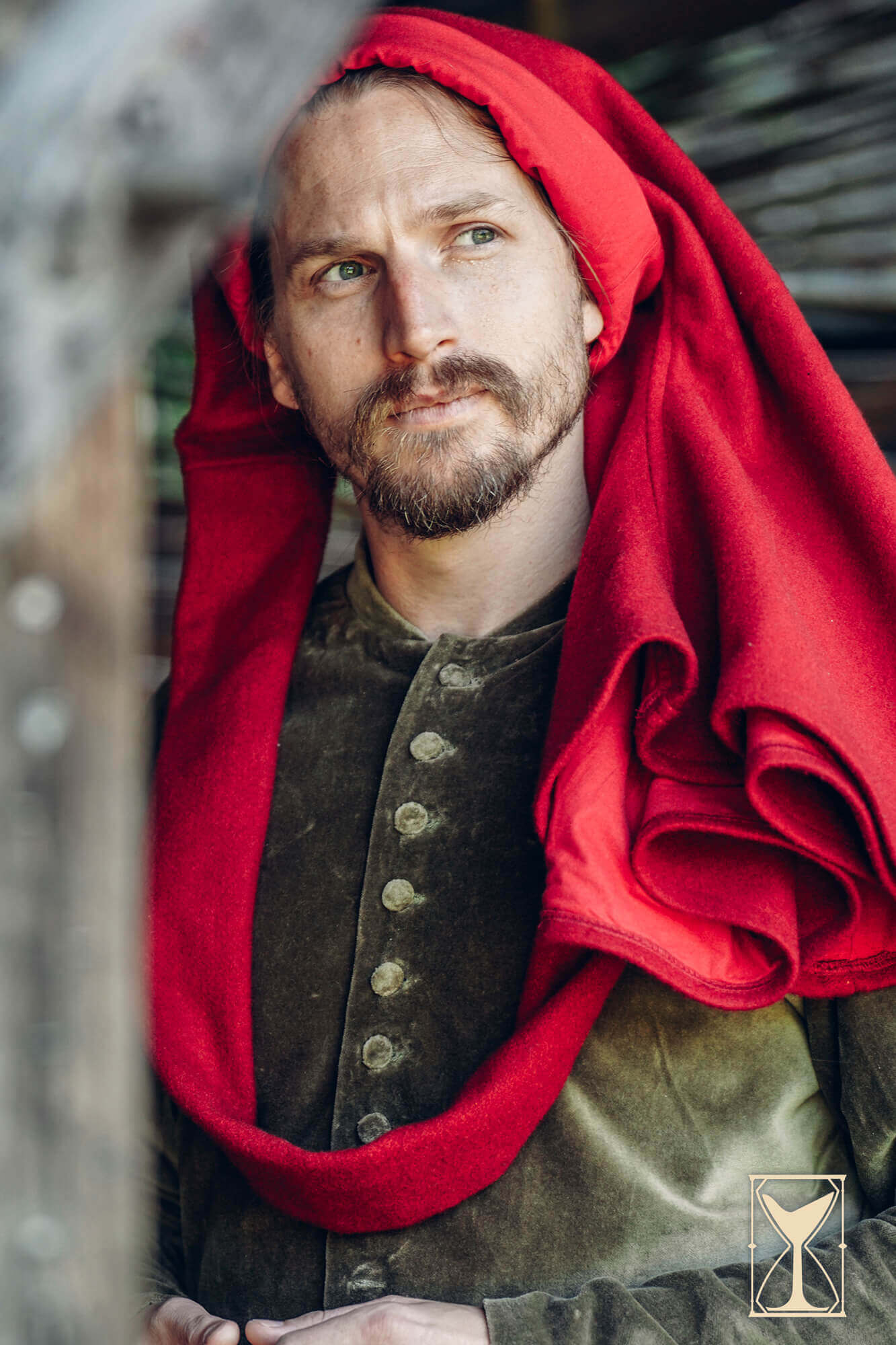Simple Liripipe Hood - Brushed Wool model wearing a red hooded medieval chaperon with a green tunic.