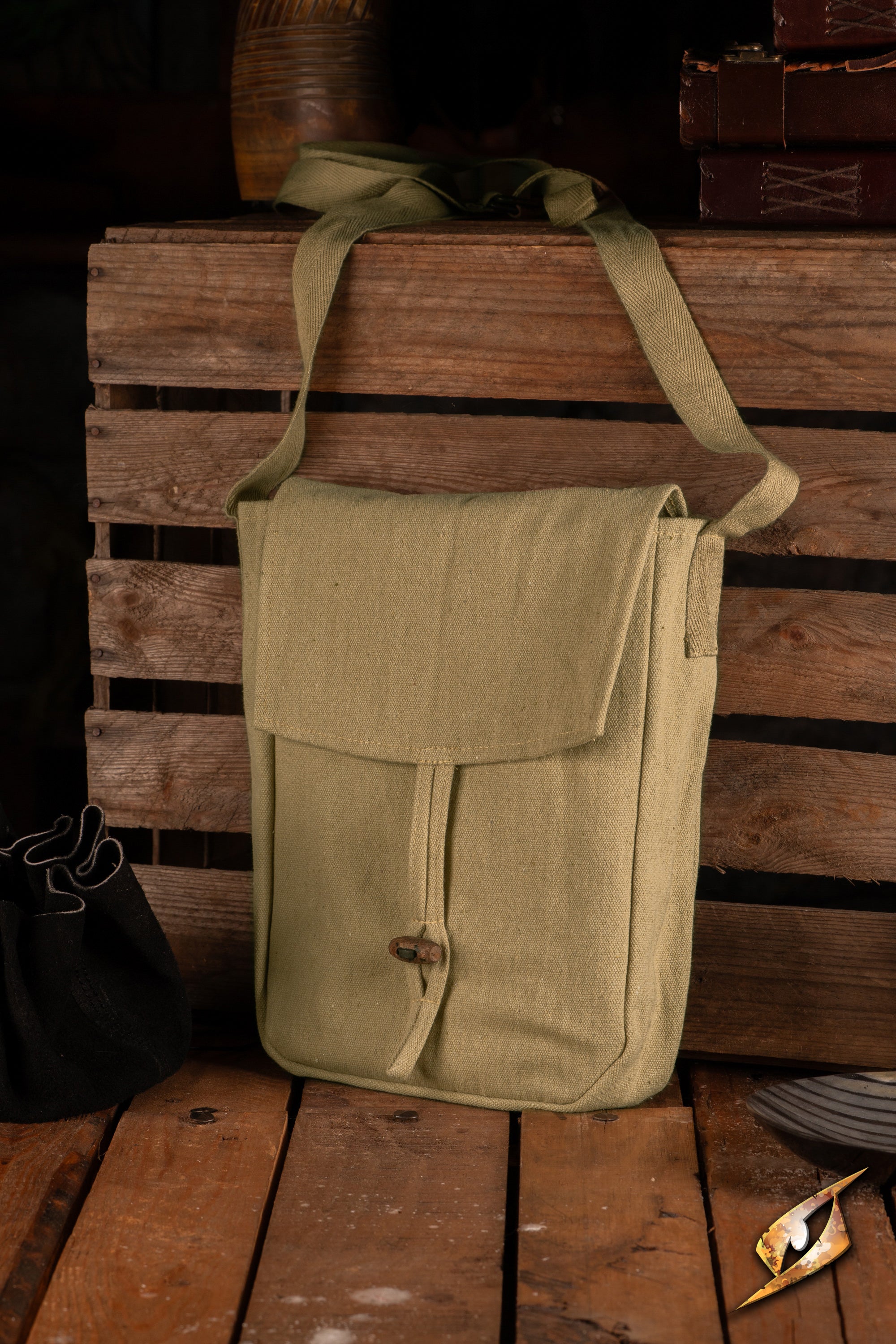 Traveler Satchel - Canvas displayed on wooden crate, showcasing its durable cotton material and simple design.