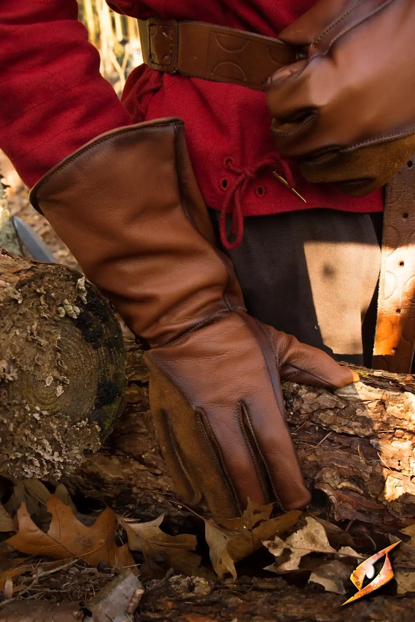 Falcon Gloves worn while handling logs, showcasing the ox brown leather and long cuffs for forearm protection.