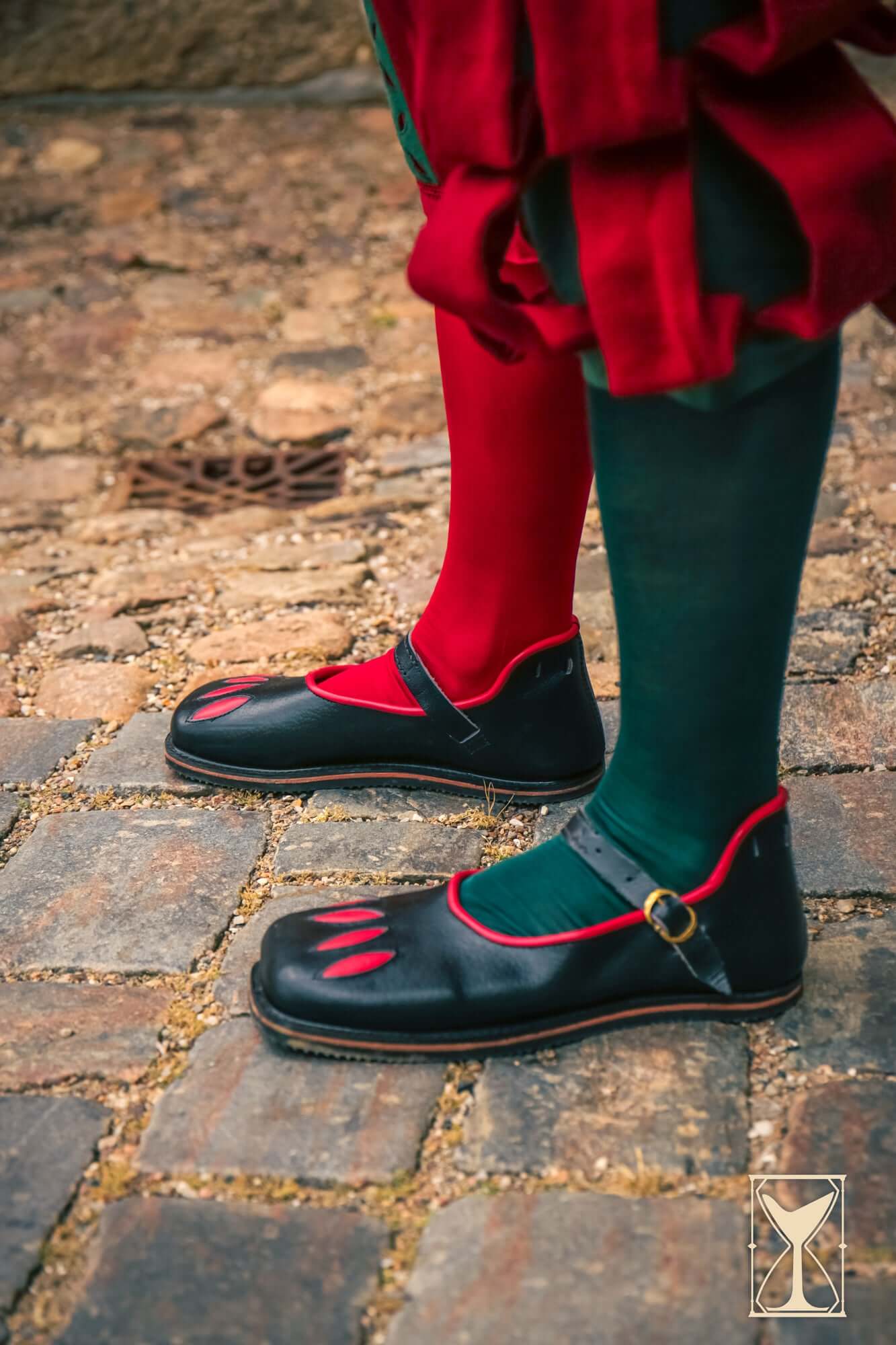 Rich Landsknecht Shoes displayed on a cobblestone street, showcasing a flamboyant Renaissance style.