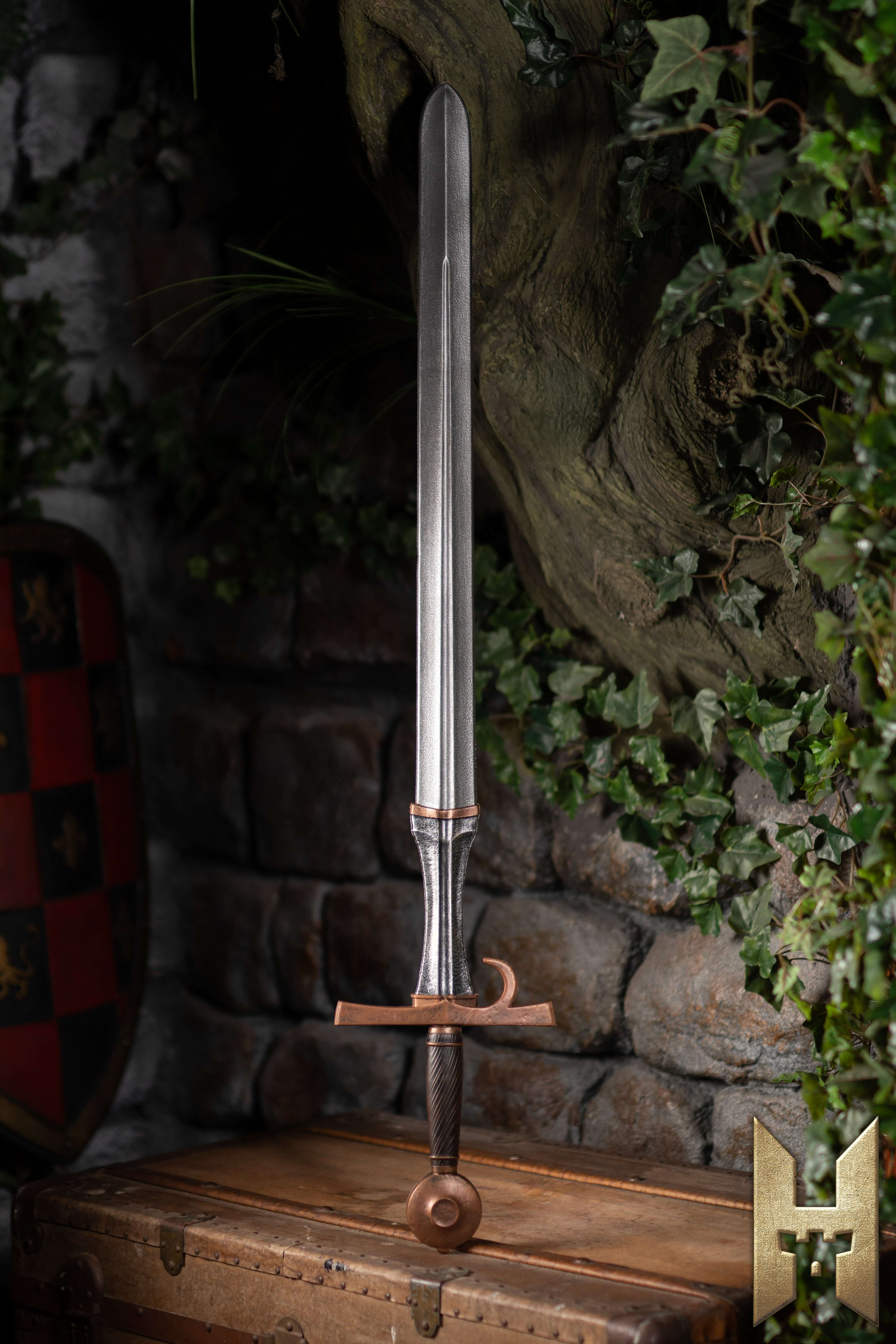 Milanese Sword displayed on a wooden chest with a stone background, showcasing its elegant and durable design.