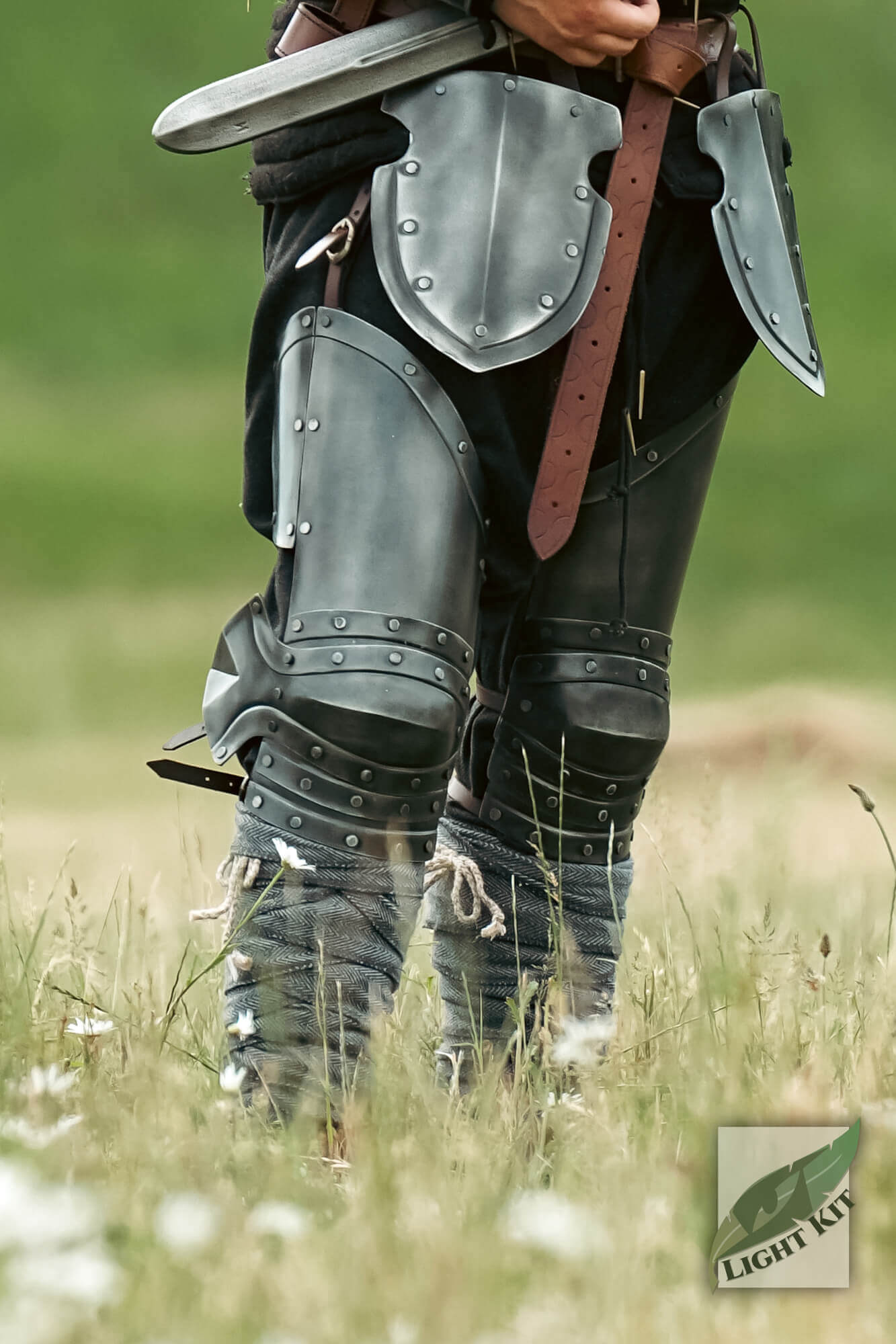 Captain Leg Protection - Light Kit showcased on a warrior in a field, featuring full leg coverage and riveted detail.