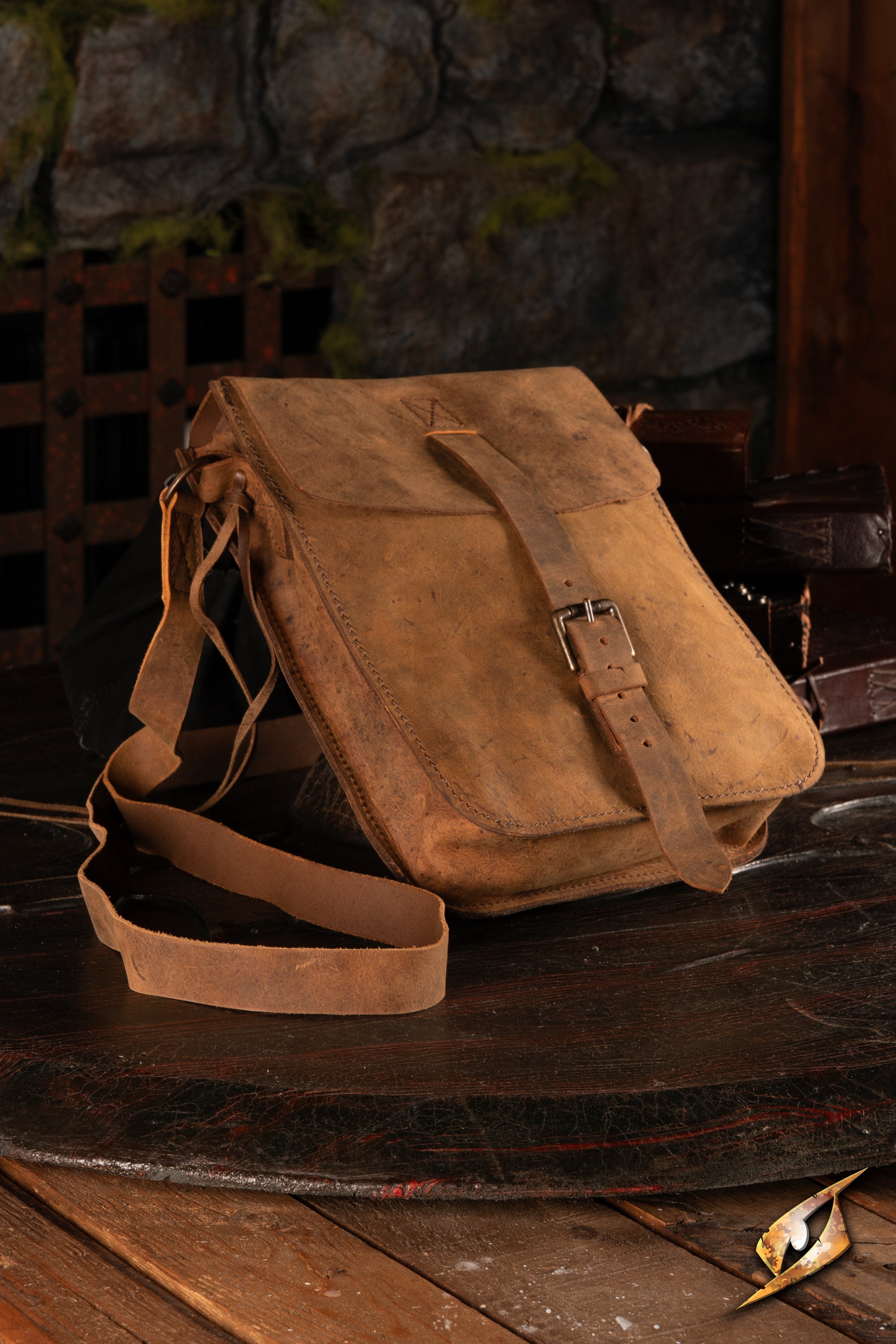 Traveler's Satchel – Pull-Up Leather resting on a rustic wooden table, showcasing its rugged design and durable material.