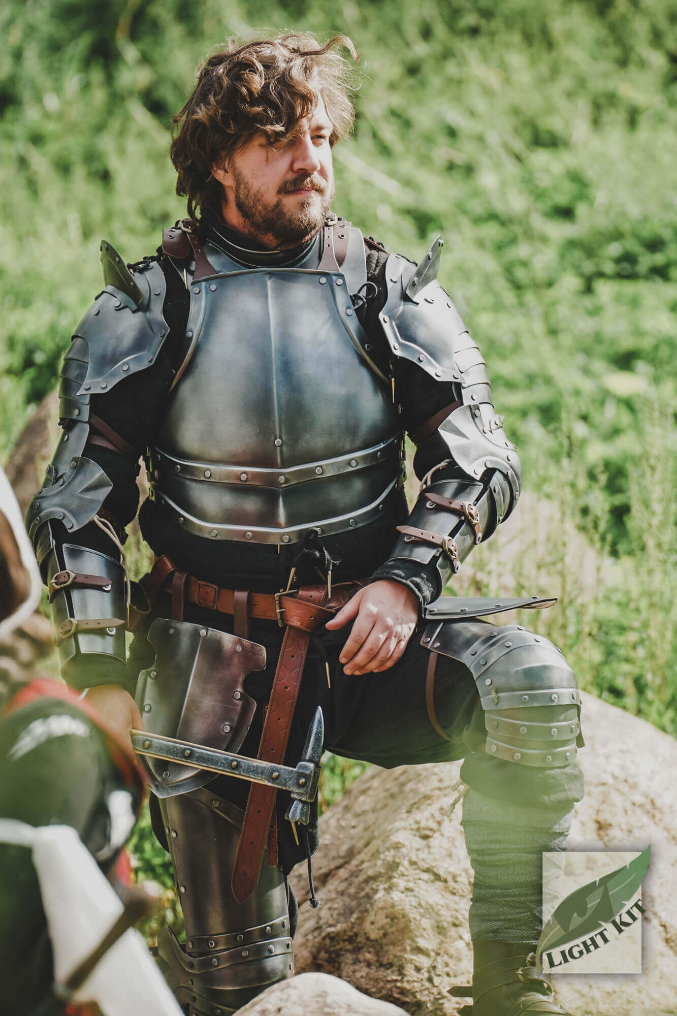 Man wearing Captain Complete Set - Light Kit armor, showcasing a sharp and polished look in a natural setting.