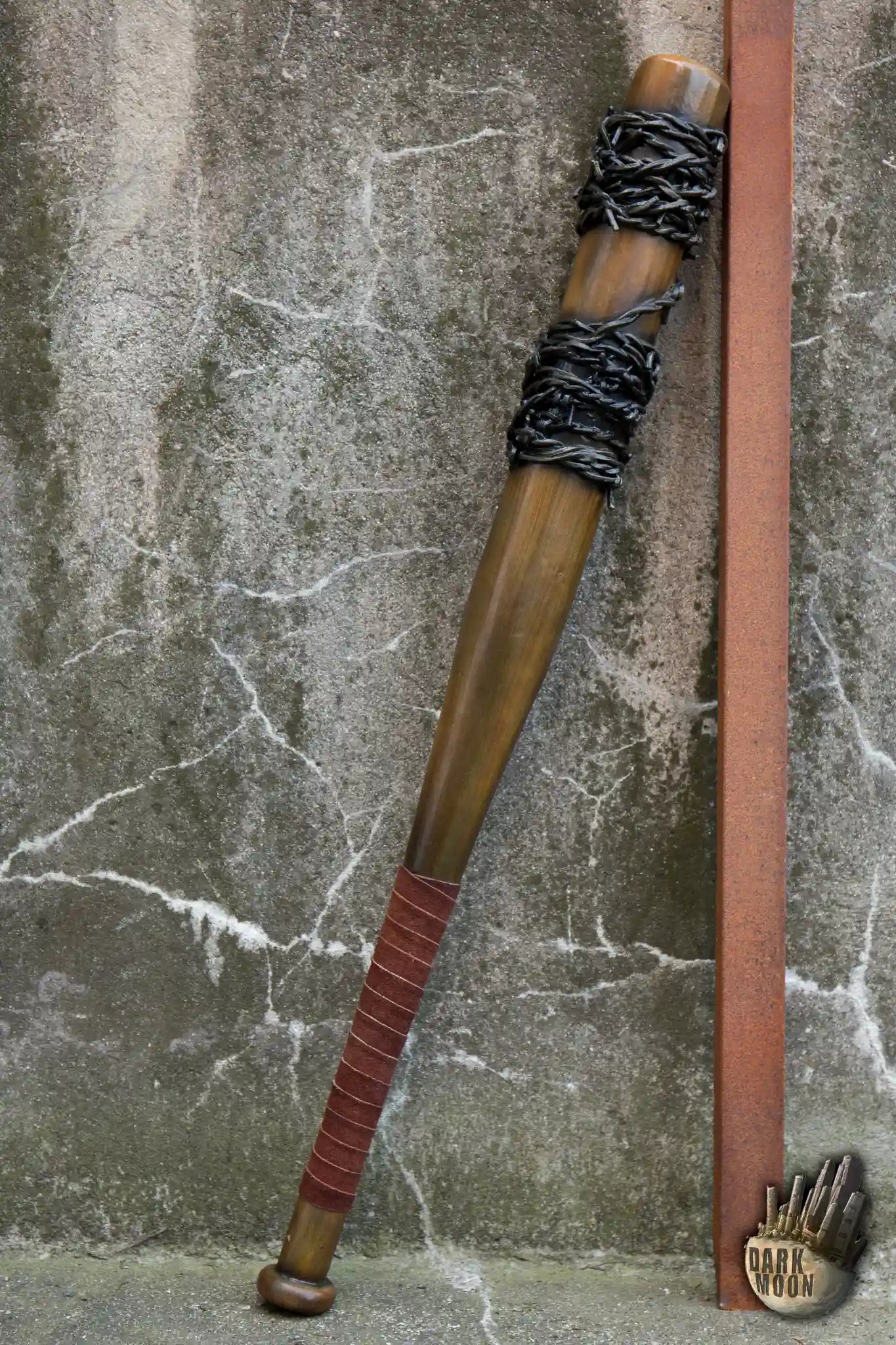 Barbed Wire Bat leaning against a wall, featuring a wooden design with barbed wire wrapped around the handle.