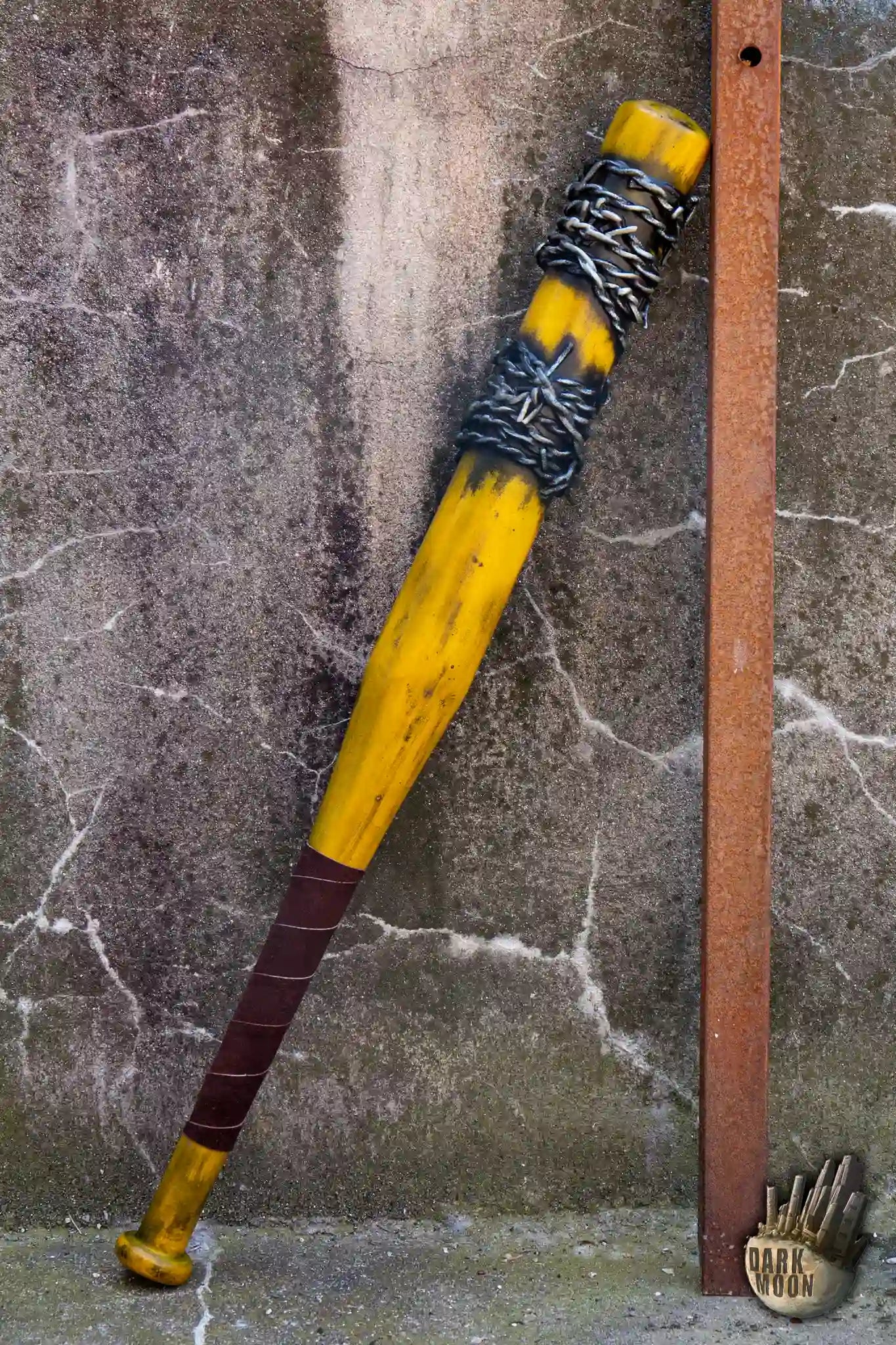Barbed Wire Bat resting against a wall, featuring a striking blue design with barbed wire accents for a post-apocalyptic look.