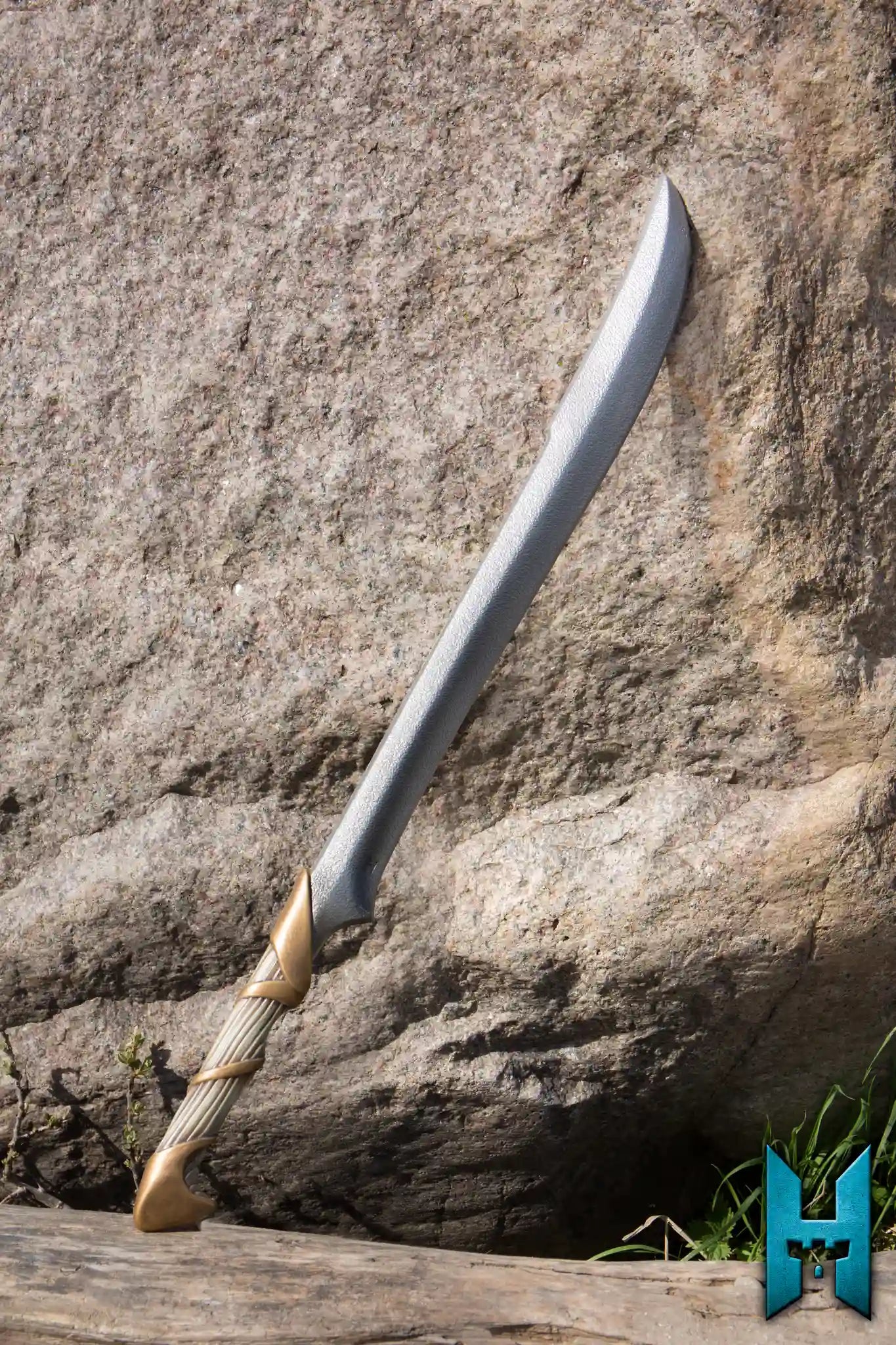 Elven Hunter Blade displayed against a rocky background, showcasing its elegant design and craftsmanship.