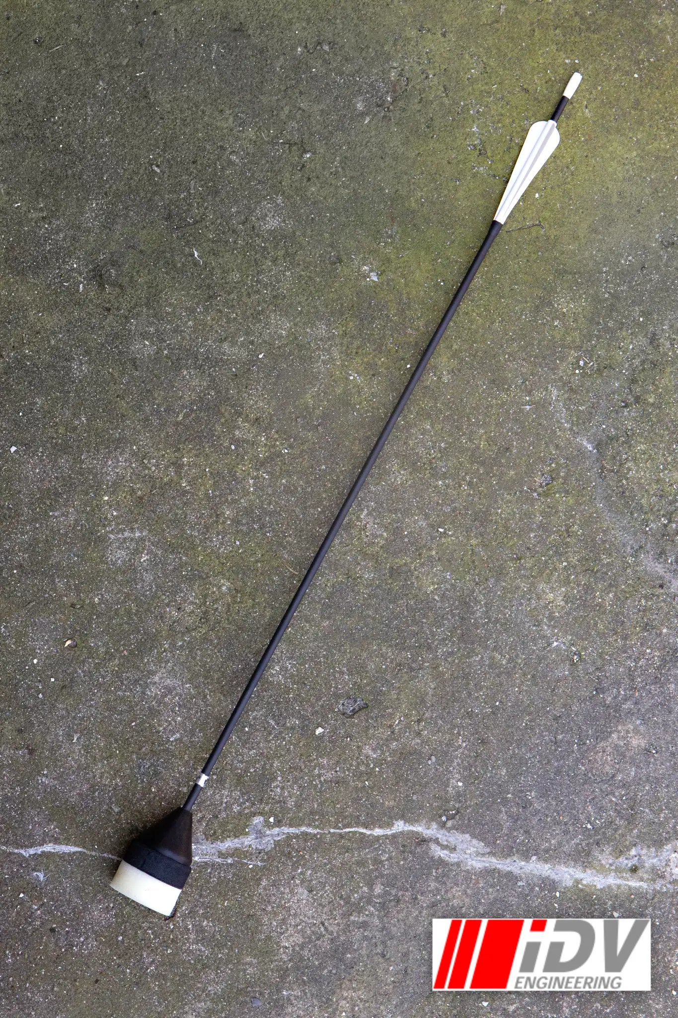 Arrow - Flat Head - Sleeved lying on a concrete surface, showcasing its sleek design and features.