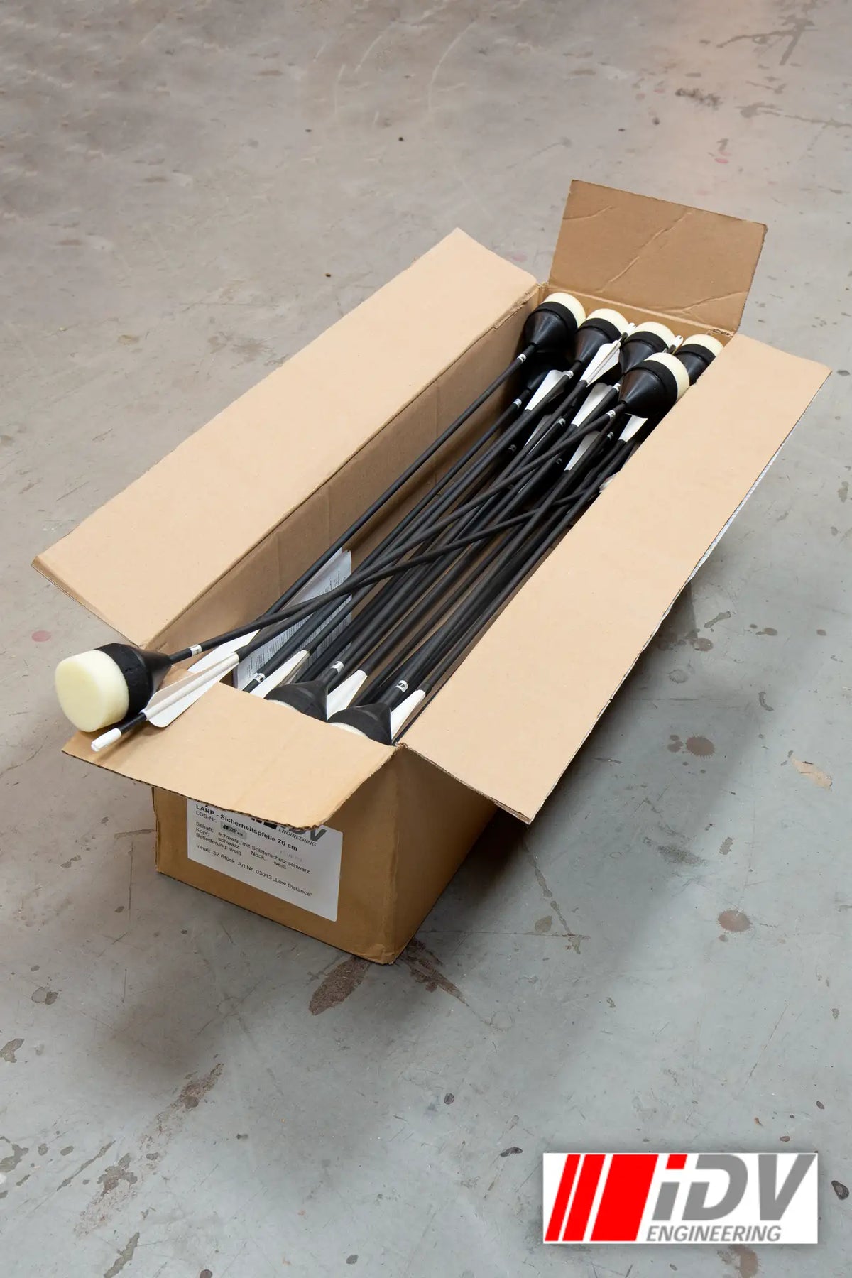 Arrow - Flat Head - Sleeved in a box, showcasing a set of archery arrows ready for practice.