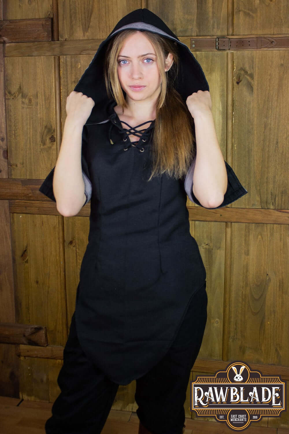 Model wearing the Briannan Ranger Tunic from Rawblade with a wide hood and short sleeves.