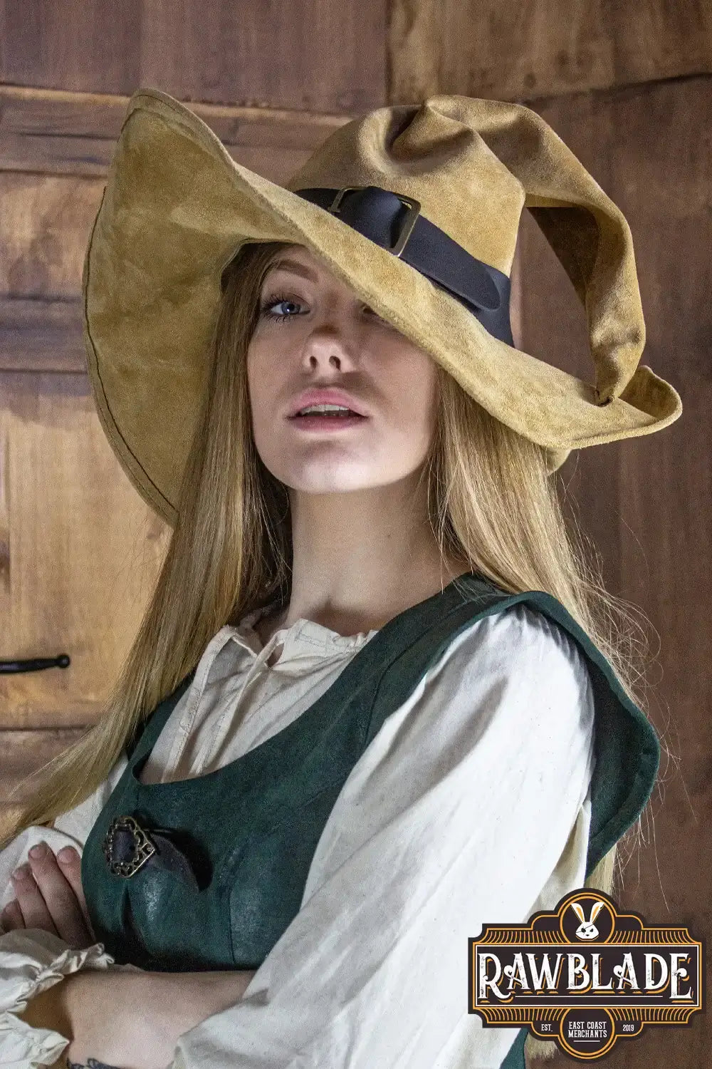 Light brown Wikka The Witch Hat Split Leather worn by a model, showcasing its pointed design and molded wings.