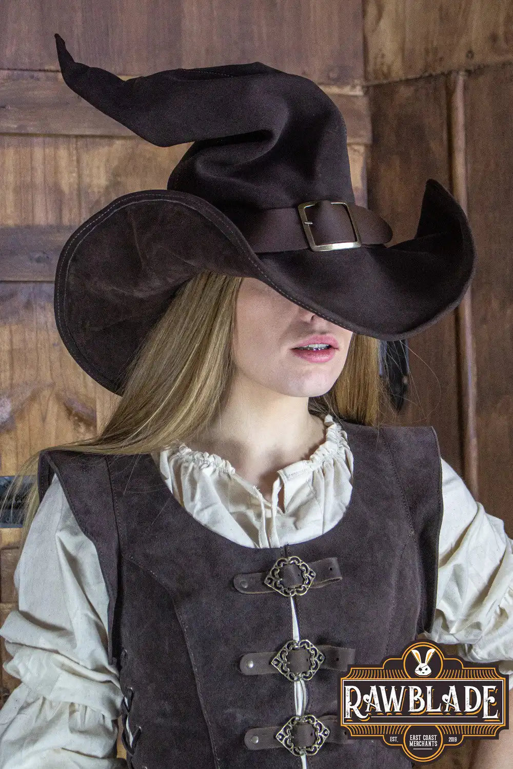 Wikka The Witch Hat Split Leather in brown worn by a model, showcasing its elegant design and leather finish.