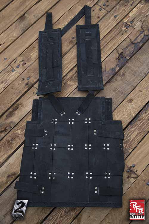 2nd Quality Armour tactical vest displayed on wooden floor background.