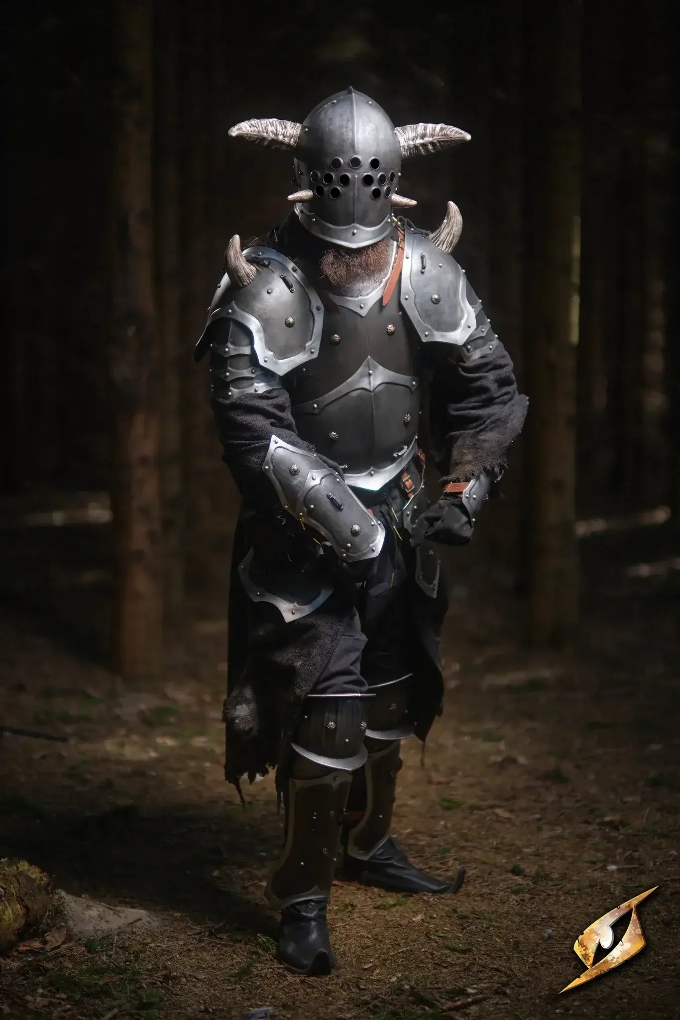 A warrior in a detailed helmet and armour set stands in the woods, showcasing impressive Armour Sets.
