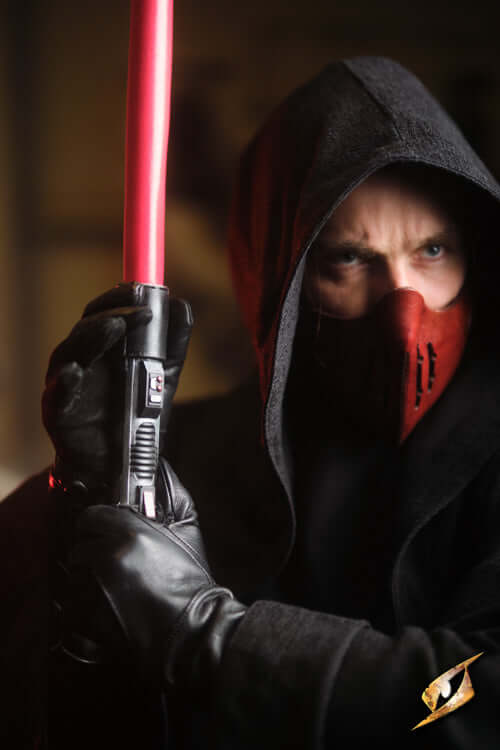 A mysterious figure in a dark hood wielding a red lightsaber, embodying themes from the Sci-Fi genre.