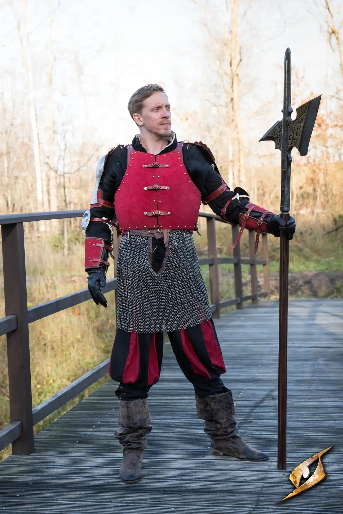 A warrior in red armor holding a halberd, showcasing the historical weapon of choice for battlefield control.