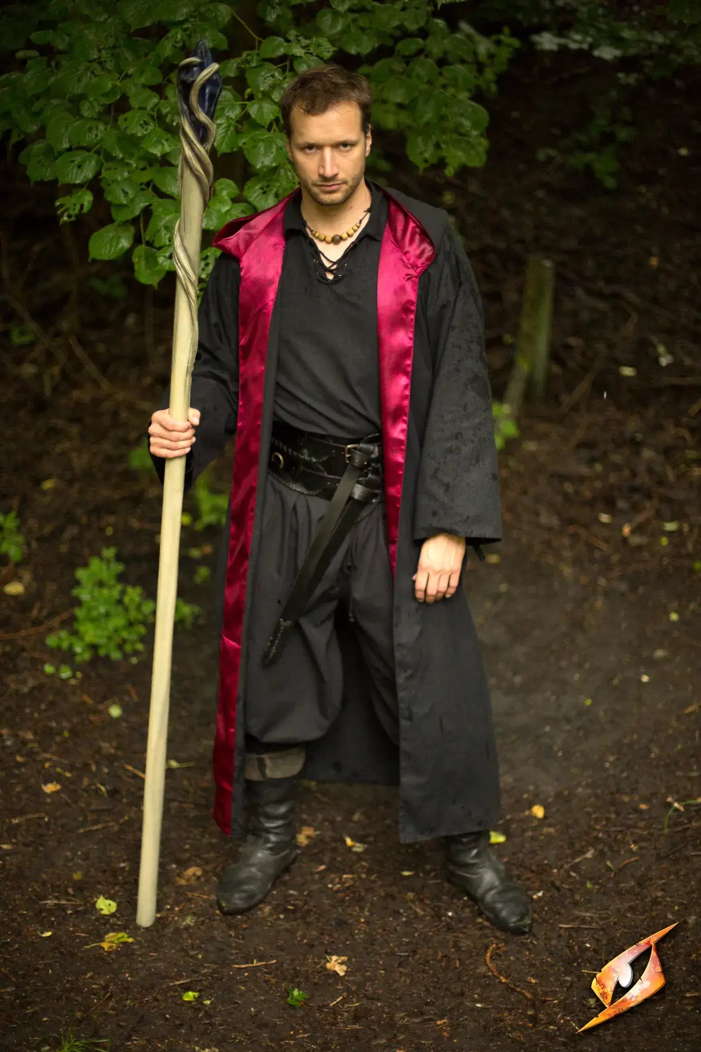 An image of man dressed as a wizard holding a wizards staff.