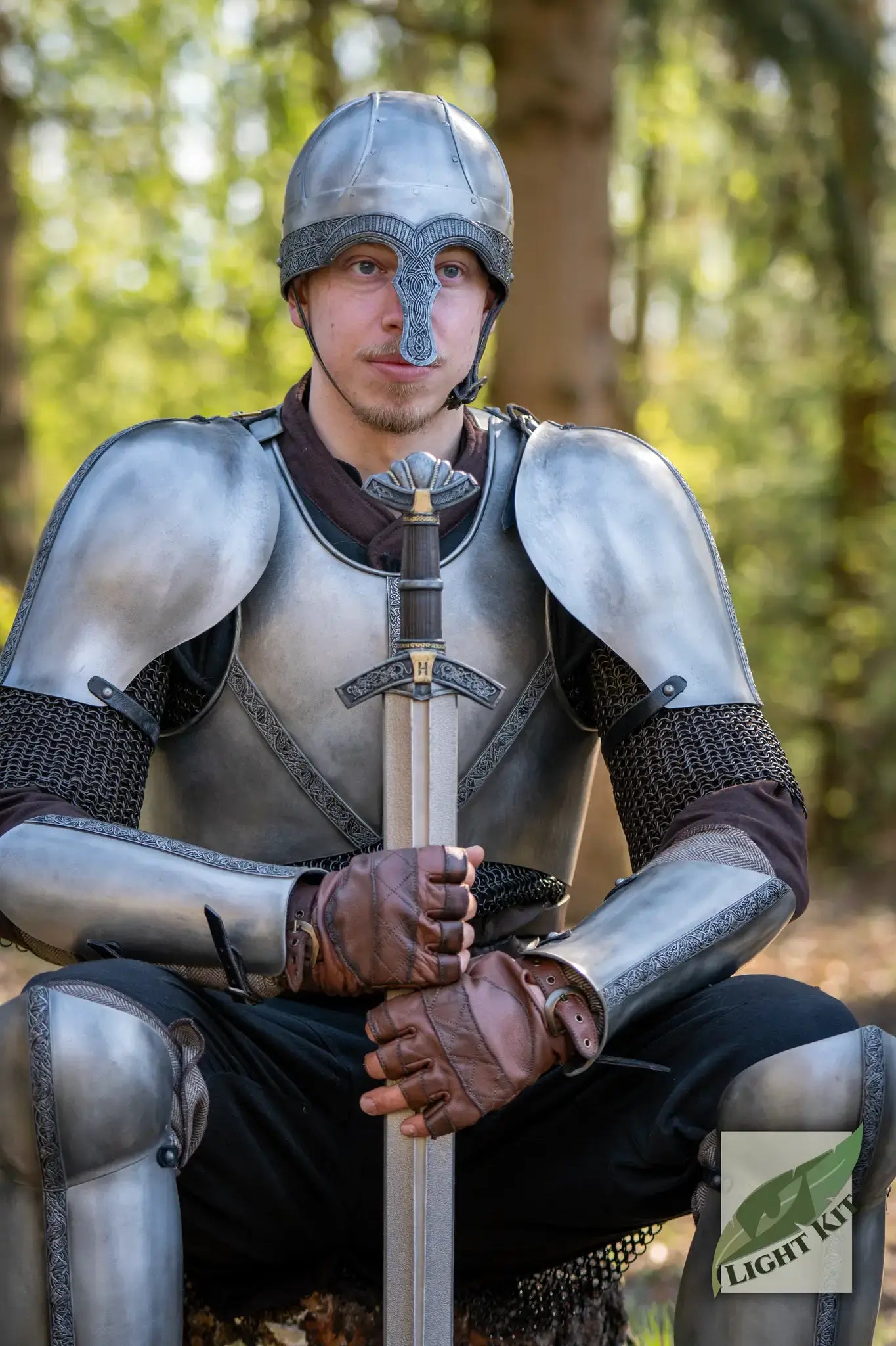 A person in PU Armor Sets sits with a sword, showcasing the detailed craftsmanship of the armor in a forest setting.