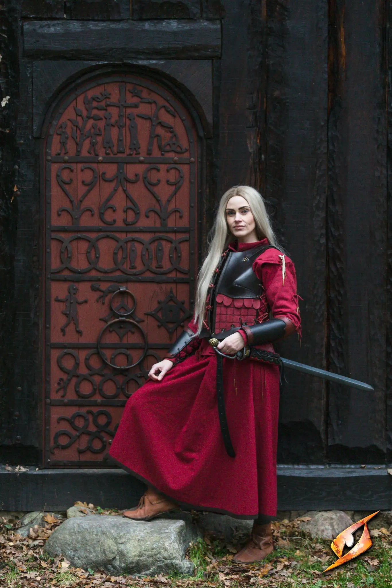 Bracers Warrior worn by a character in front of a decorative door, showcasing a medieval-inspired costume.