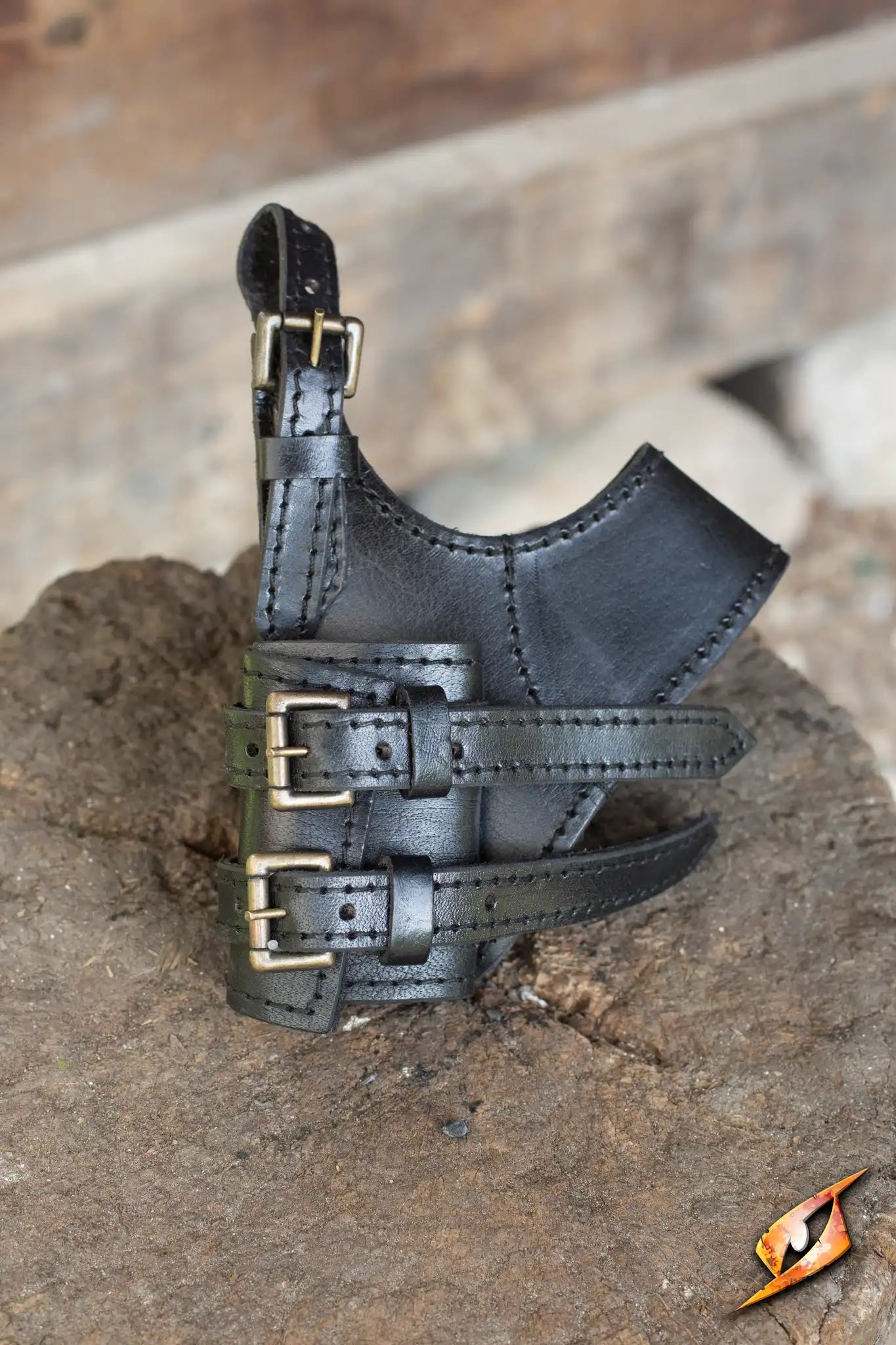 Adventurer Swordholder displayed on a rock, showcasing its black leather design and adjustable straps.