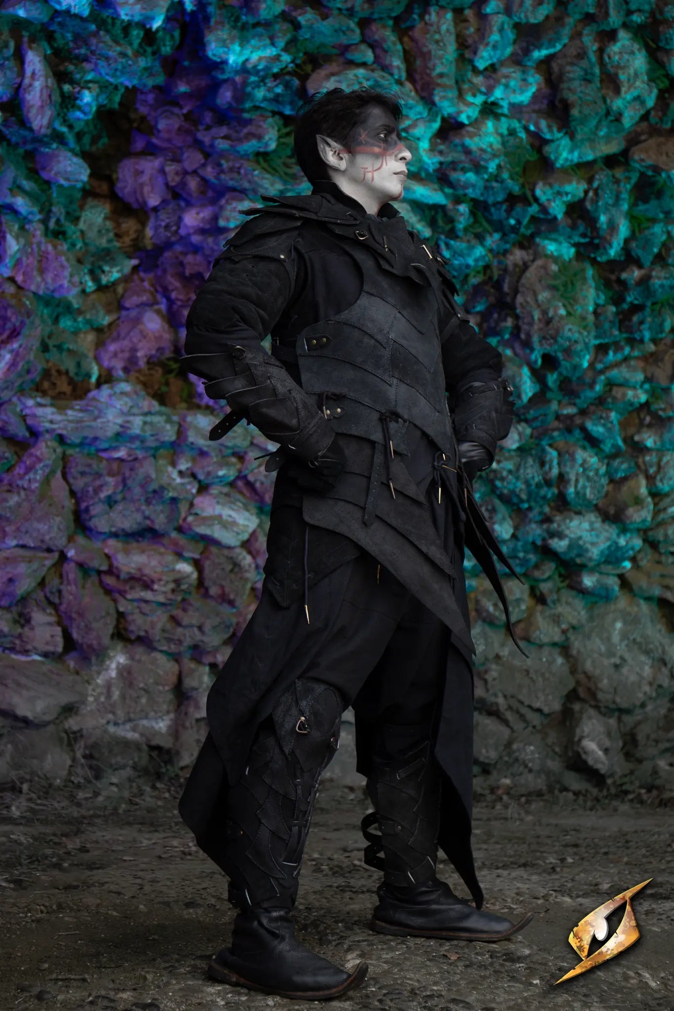 Person wearing the Shadow Armour Set - Suede, standing against a colorful rocky background.