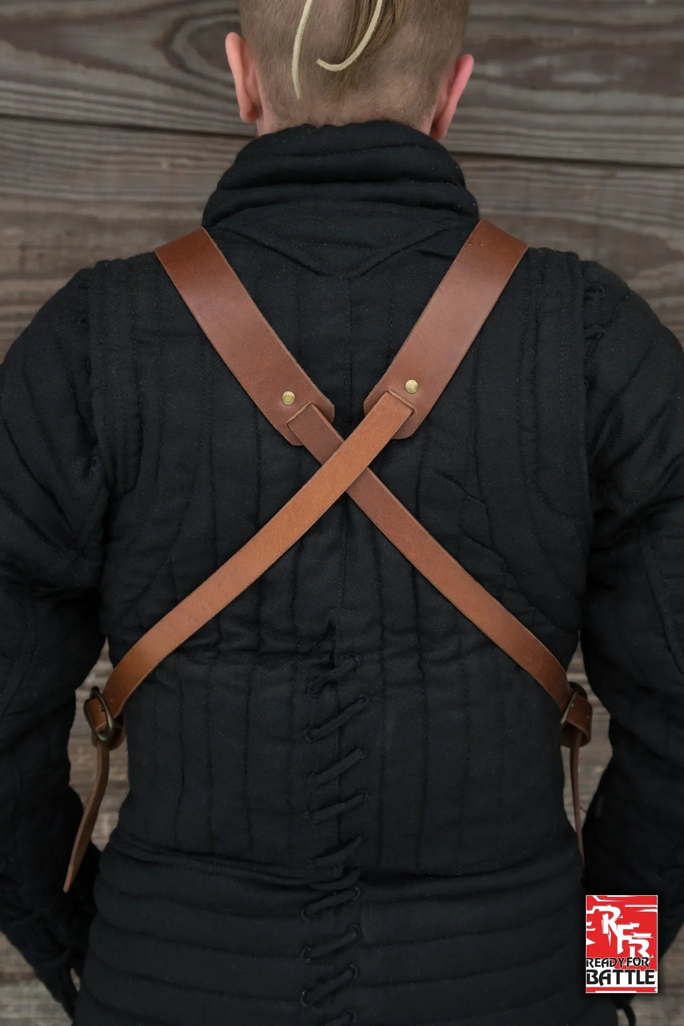 RFB Breastplate featuring crisscross leather straps on a black padded garment.