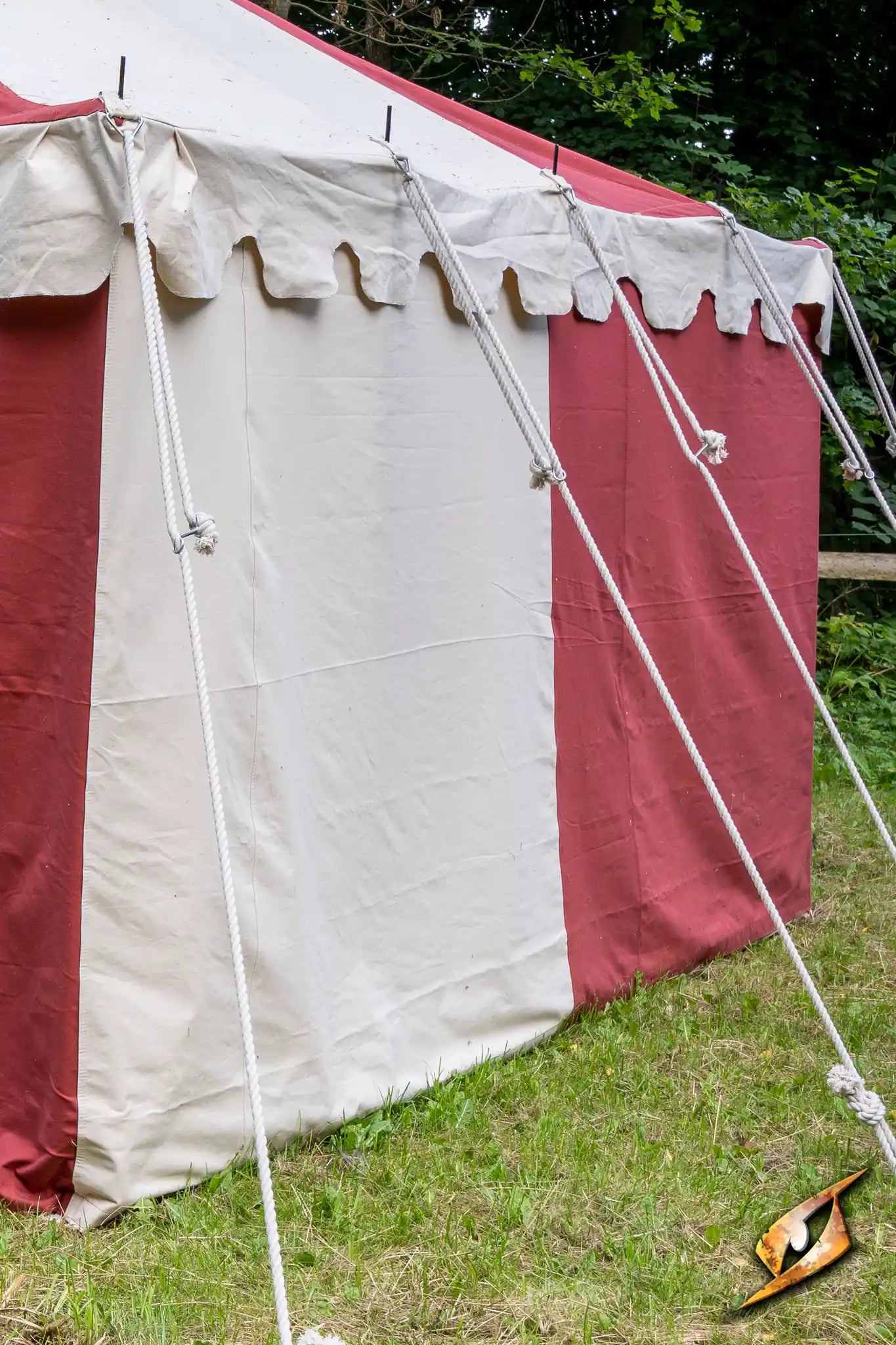 Marquee Tent - Sides - 5x8m with red and white fabric, secured with ropes in a grassy area.