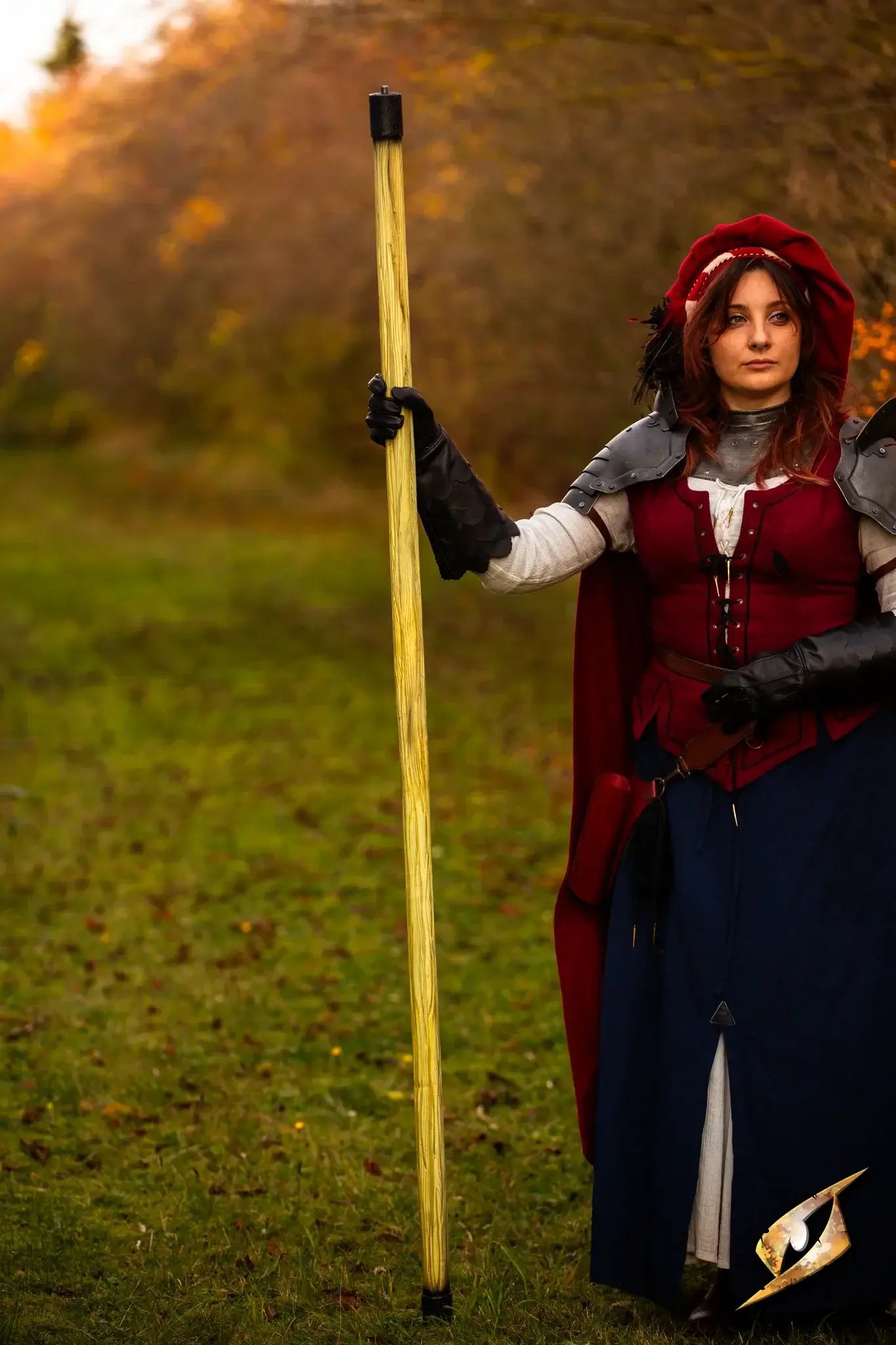 Battle Standard - Long Pole held by a woman in a costume, showcasing its tall and commanding design in an autumn setting.