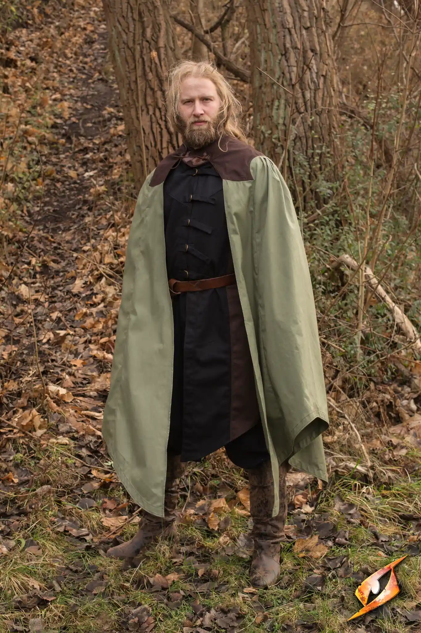 Cape Edrahil knee-length cape shown in a forest setting, featuring brown collar and green pleated fabric.
