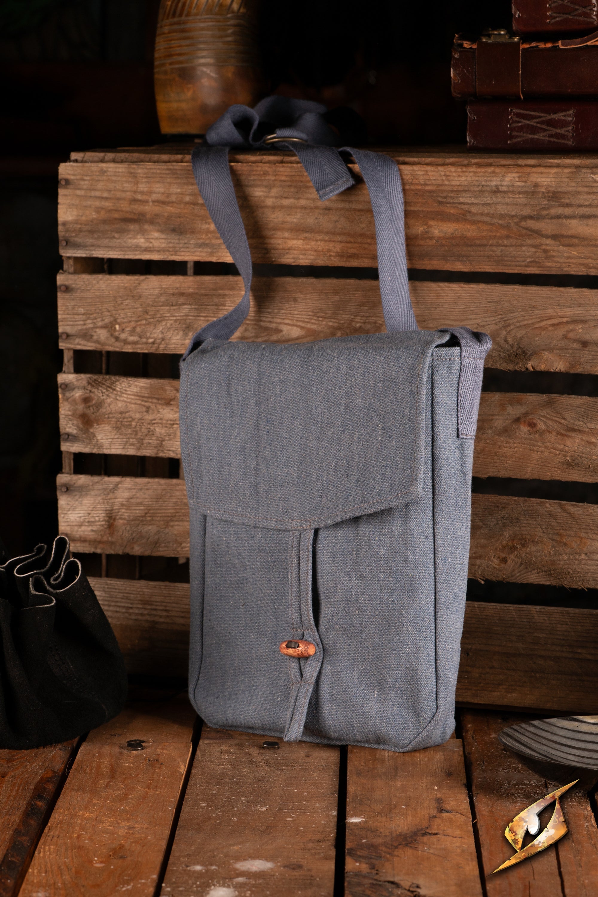 Traveler Satchel - Canvas displayed on a rustic wooden surface, showcasing its rugged design and practicality.