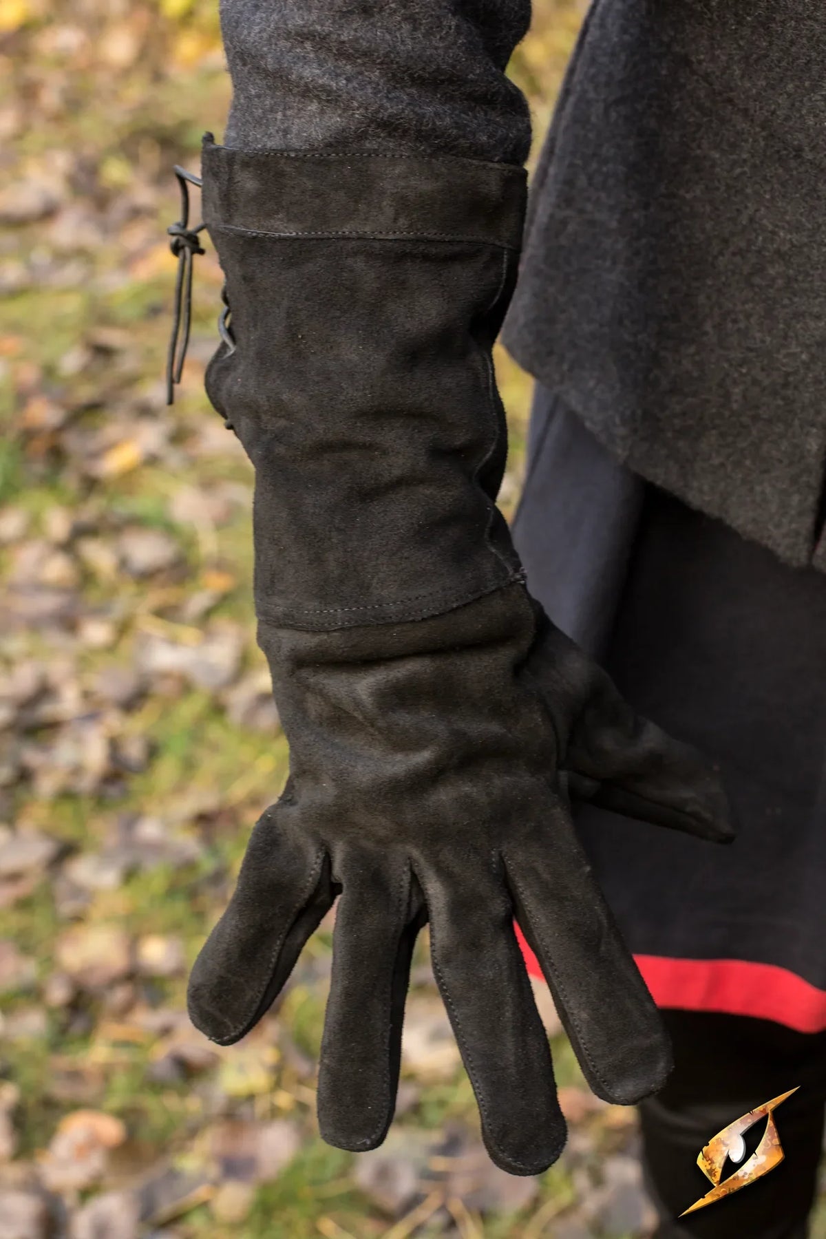 Black leather gloves displayed on a hand, designed for style and warmth in cooler weather.