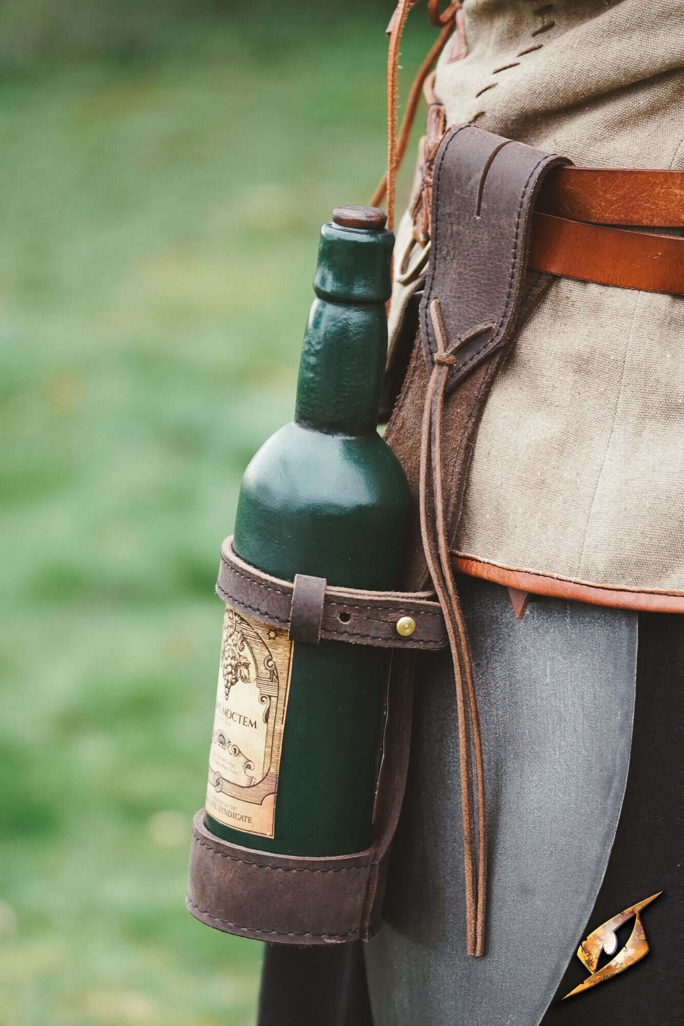 Bottle Holder - Dark Brown holding a green wine bottle securely at the hip in a rustic outdoor setting.