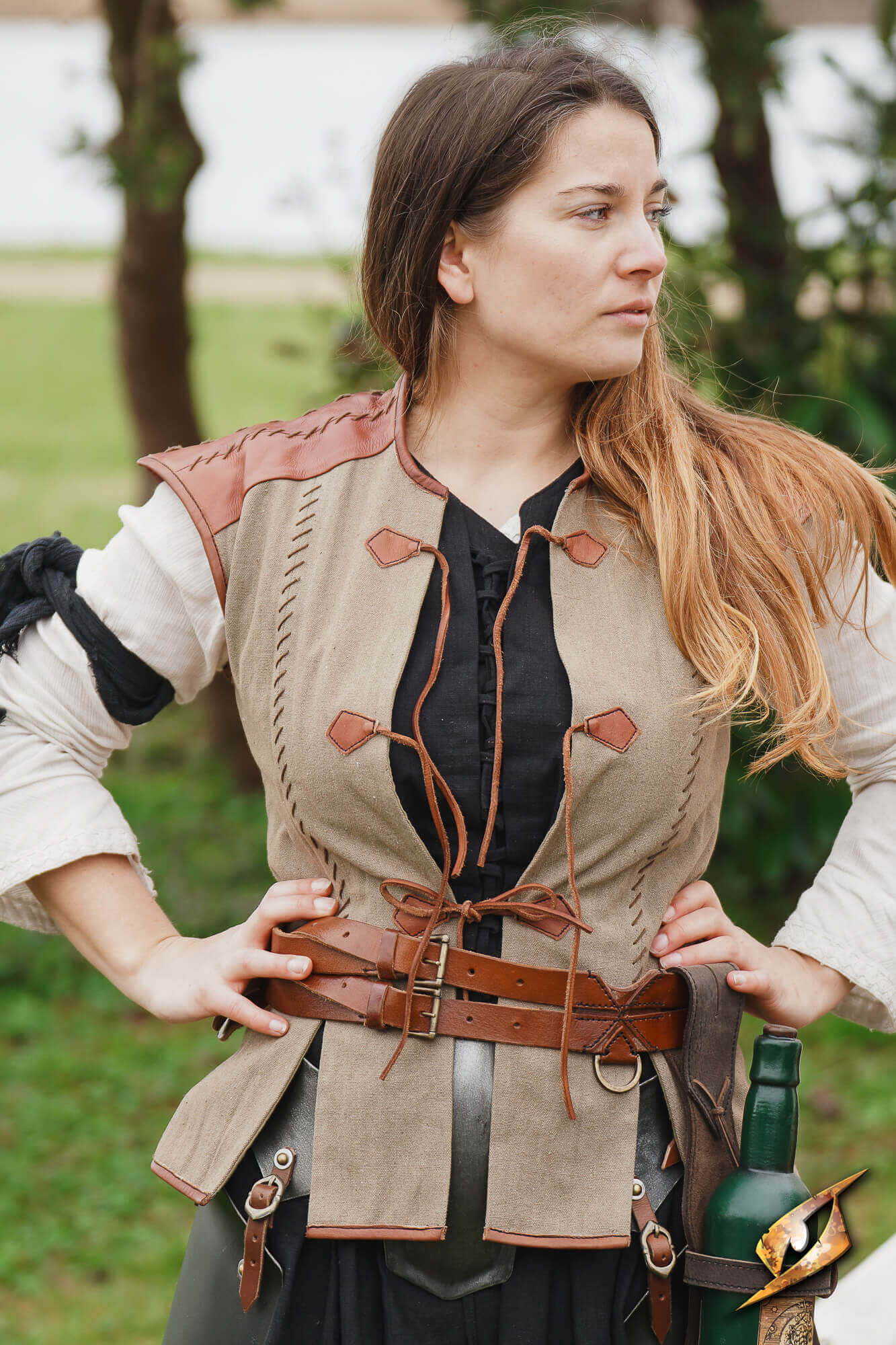 Rugged Canvas Jerkin worn by a woman outdoors, featuring leather shoulder reinforcement and decorative stitching.