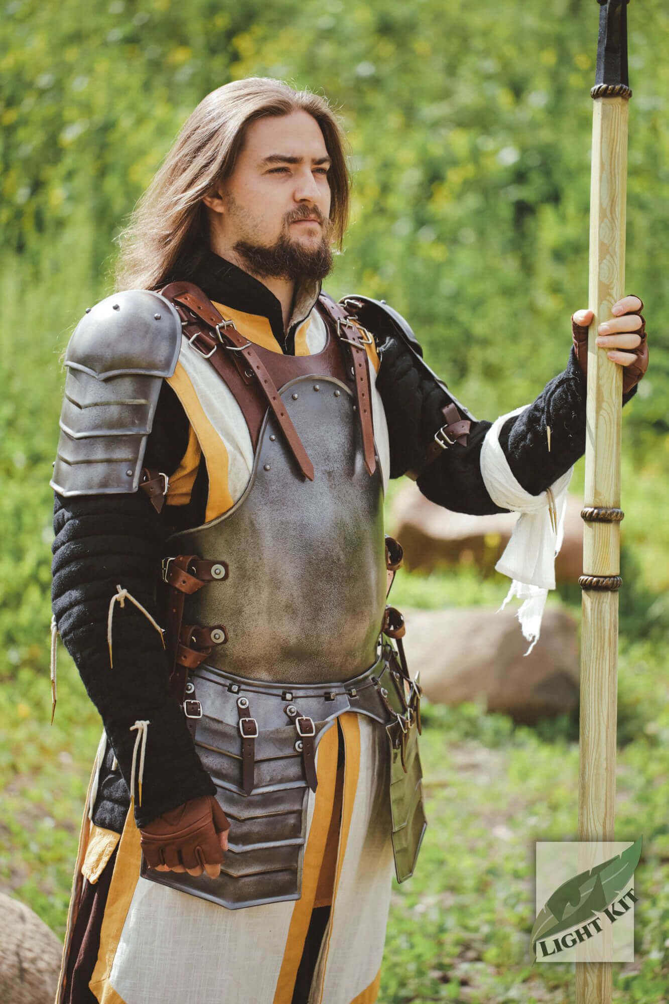 Merc Armour Set - Light Kit worn by a fighter holding a spear, showcasing its rugged and flexible design in an outdoor setting.