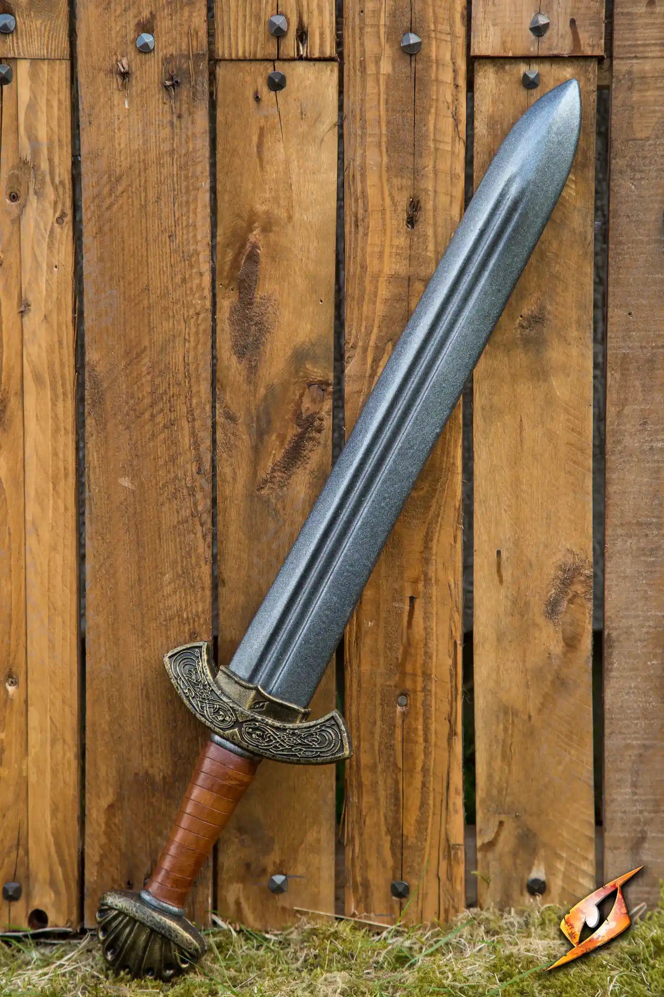 Foam sword with a detailed hilt against a wooden background
