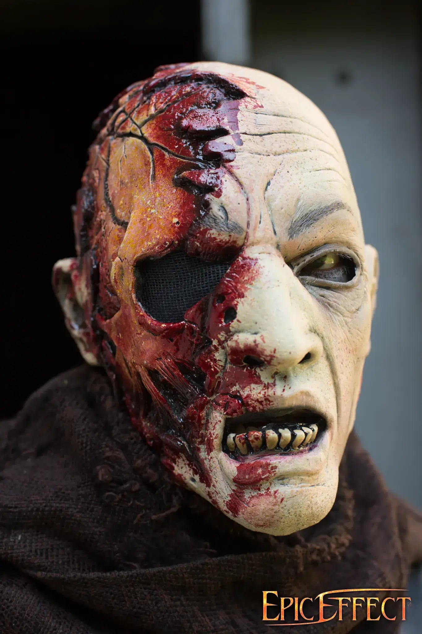 Half Face Zombie mask with gruesome details and blood effects, showcasing the horror aesthetic and undead features.
